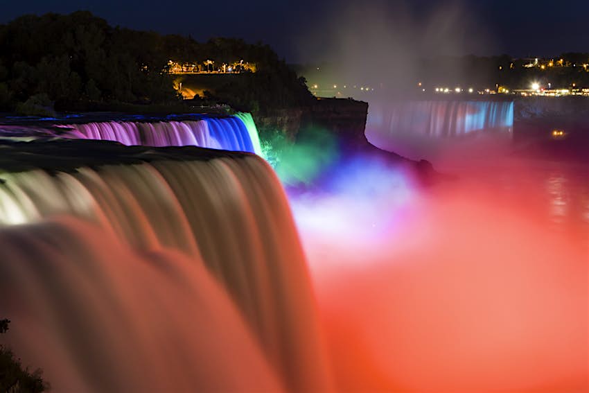 Niagara.jpg Colored lights shine on Niagara Falls, making a rainbow misty effect; Toronto day trips