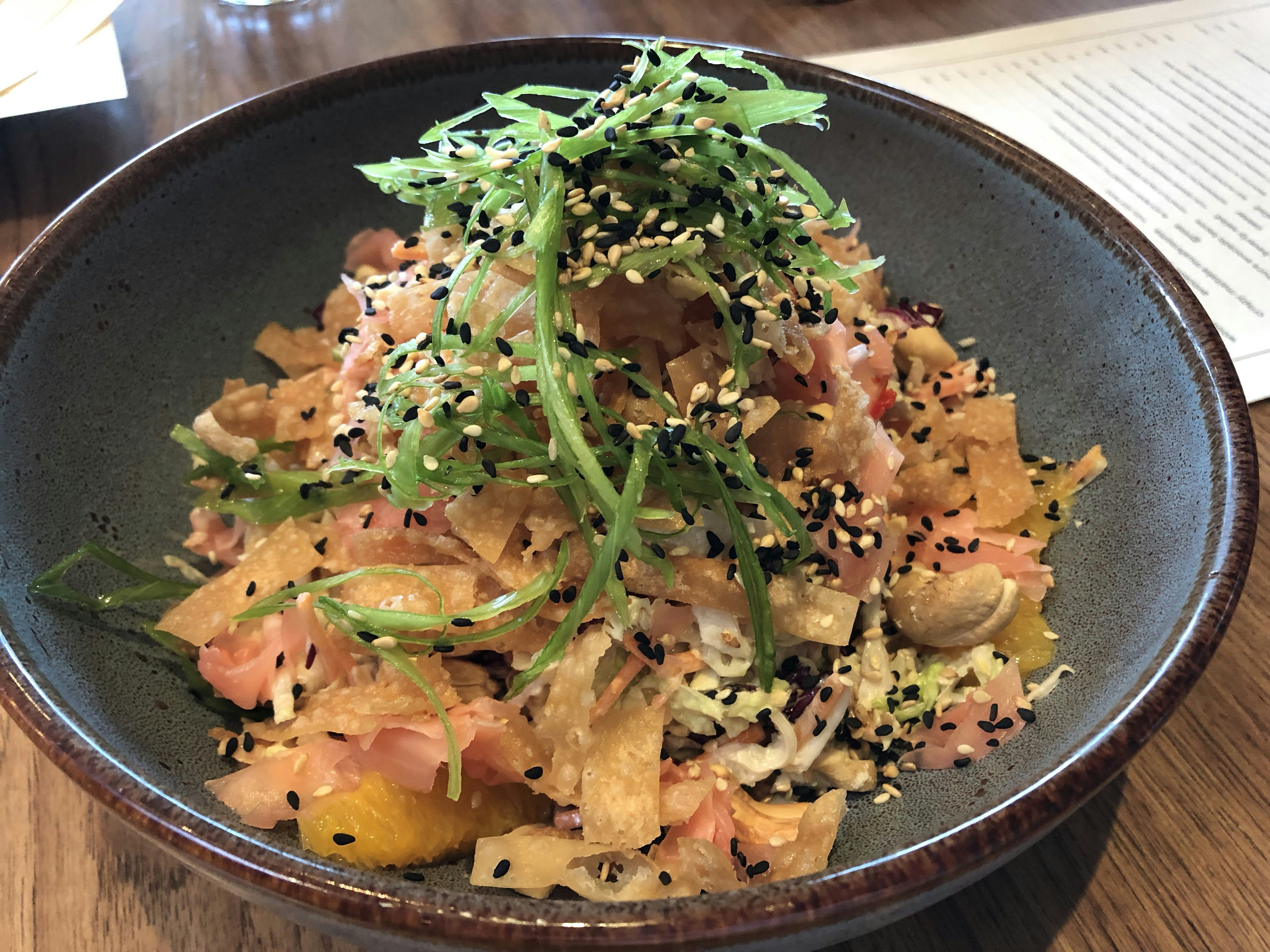 Plate piled high with shredded vegan chicken, friend wonton, cabbage and sesame seeds; LA vegan restaurants 