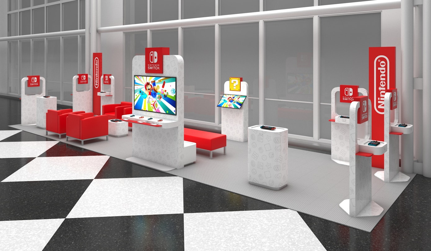 Nintendo's popup lounge at Orlando airport, with red chairs and white stations with Switches 