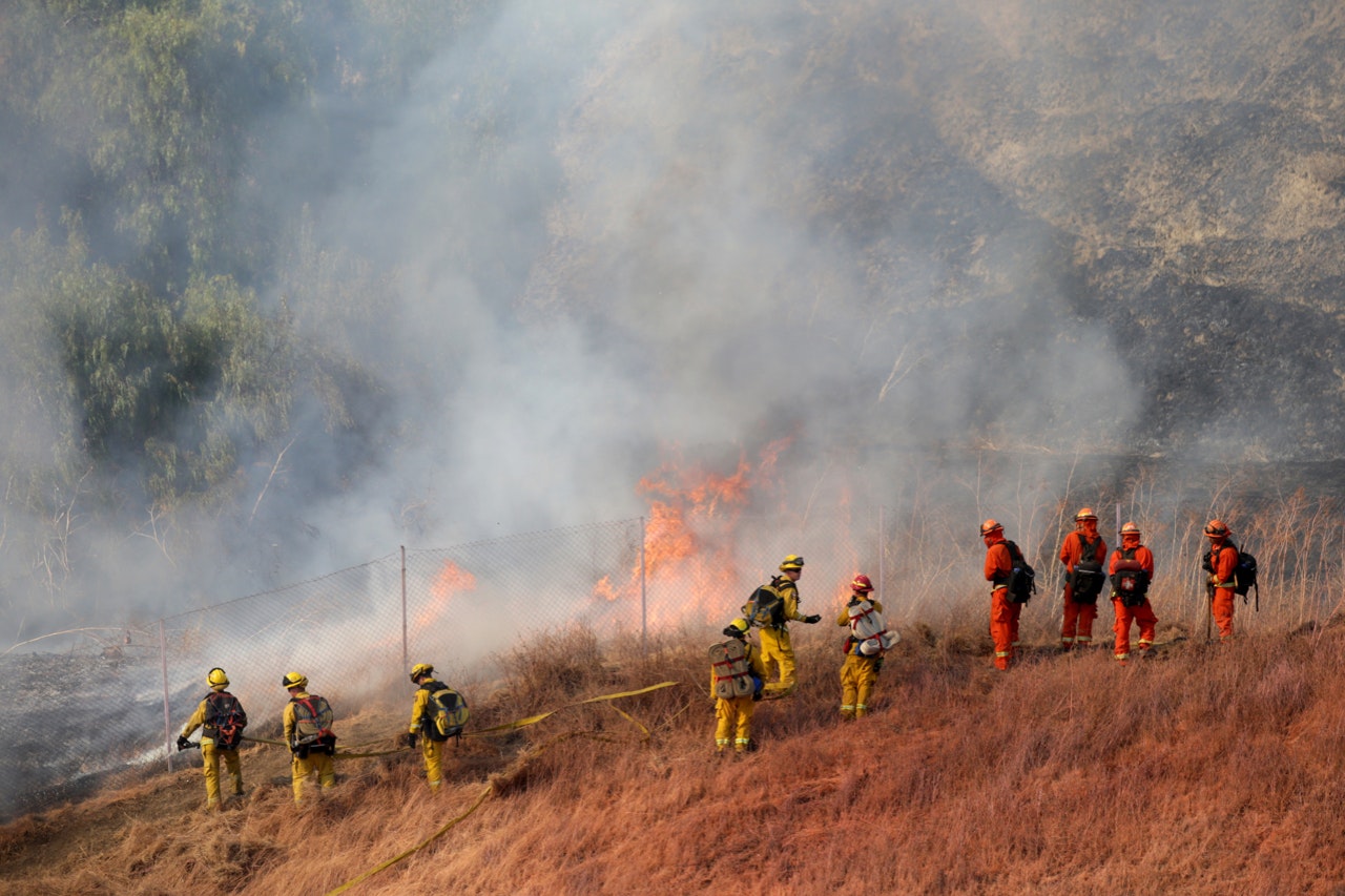 Cal Fire firefighters battle a grass fire near the NuStar Energy facility in Crockett, Calif. on Tuesday, Oct. 15, 2019