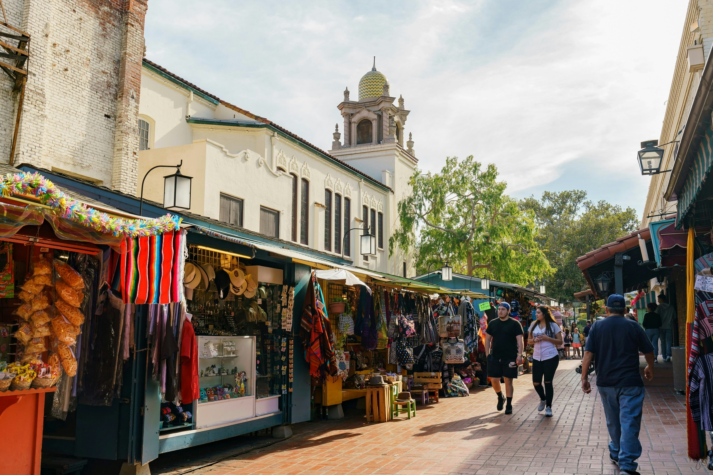 Stalls of street vendors line a historic section of Olvera St.