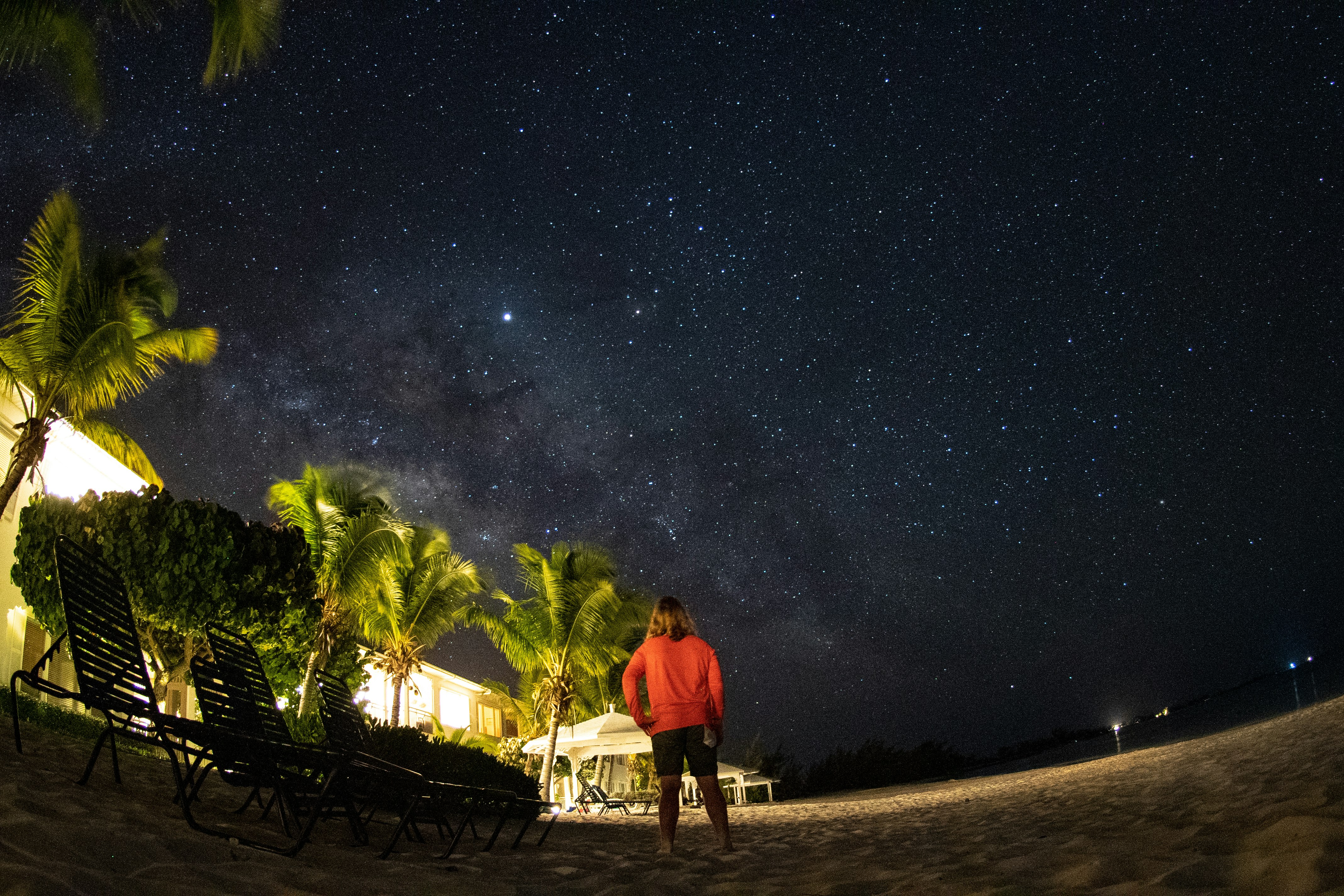 The stars shine over Cape Santa Maria Resort, as a woman stares up at the sky. 