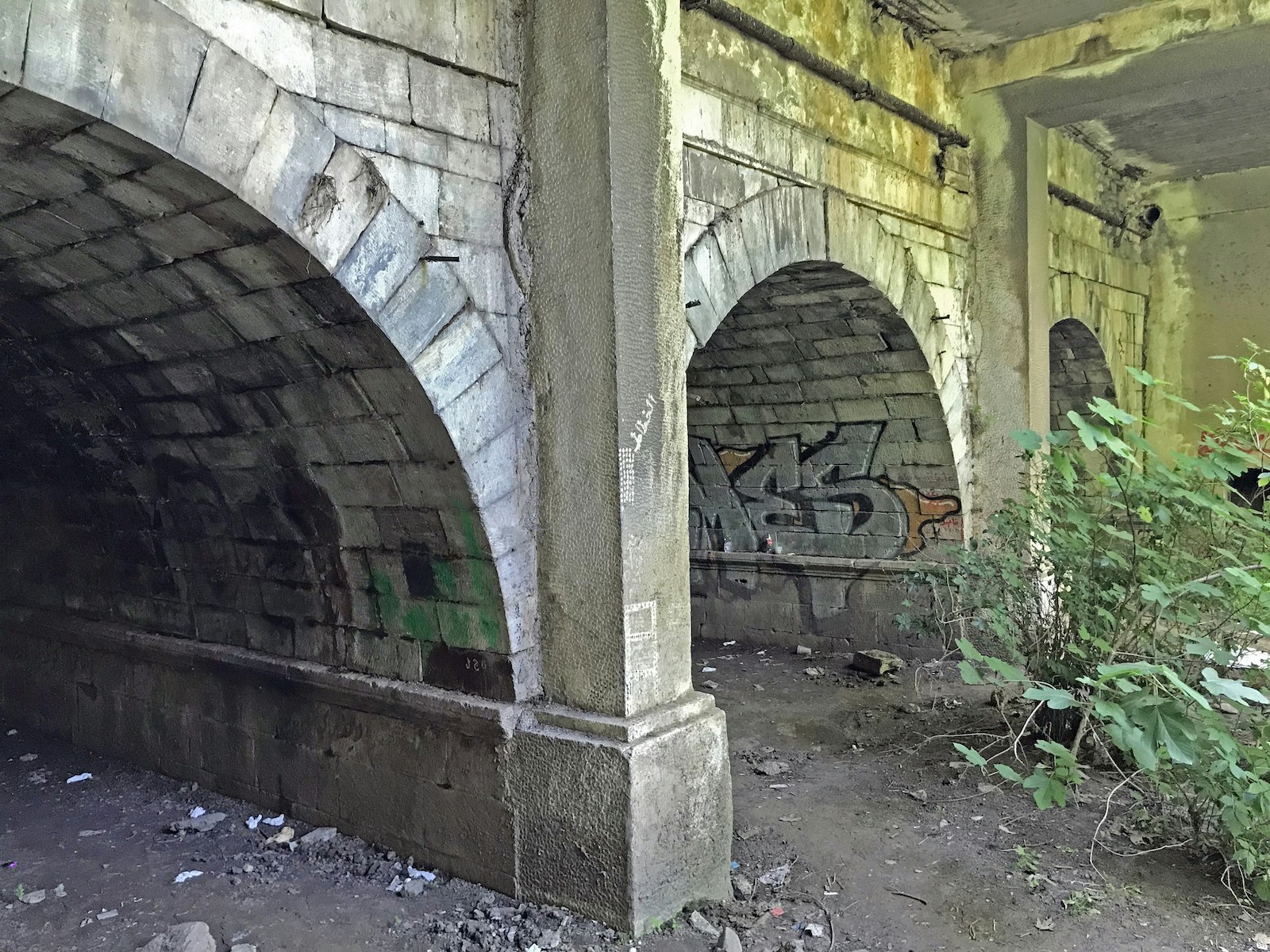 A graffitied three-tunnel bridge dating back to the days of Ott