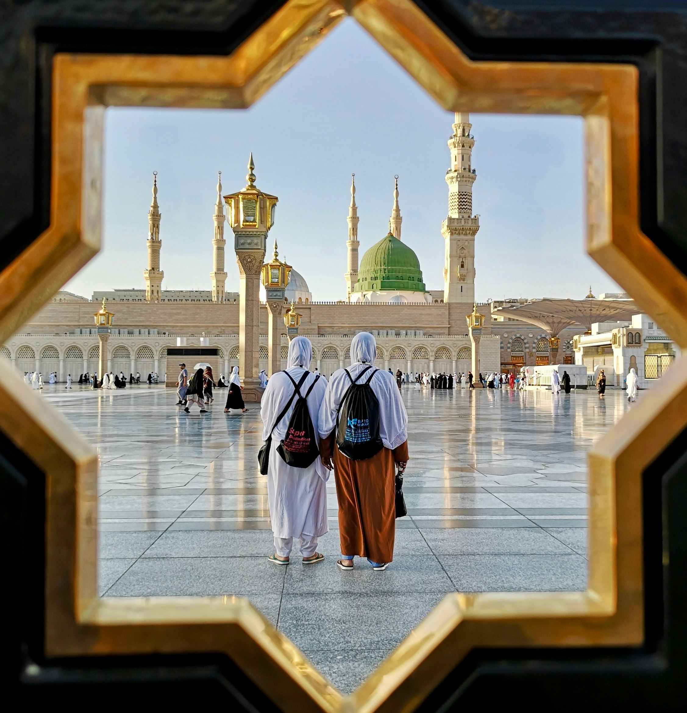 Tharik's mother and aunt stand in the square looking towards the Prophet's Mosque in Madinah