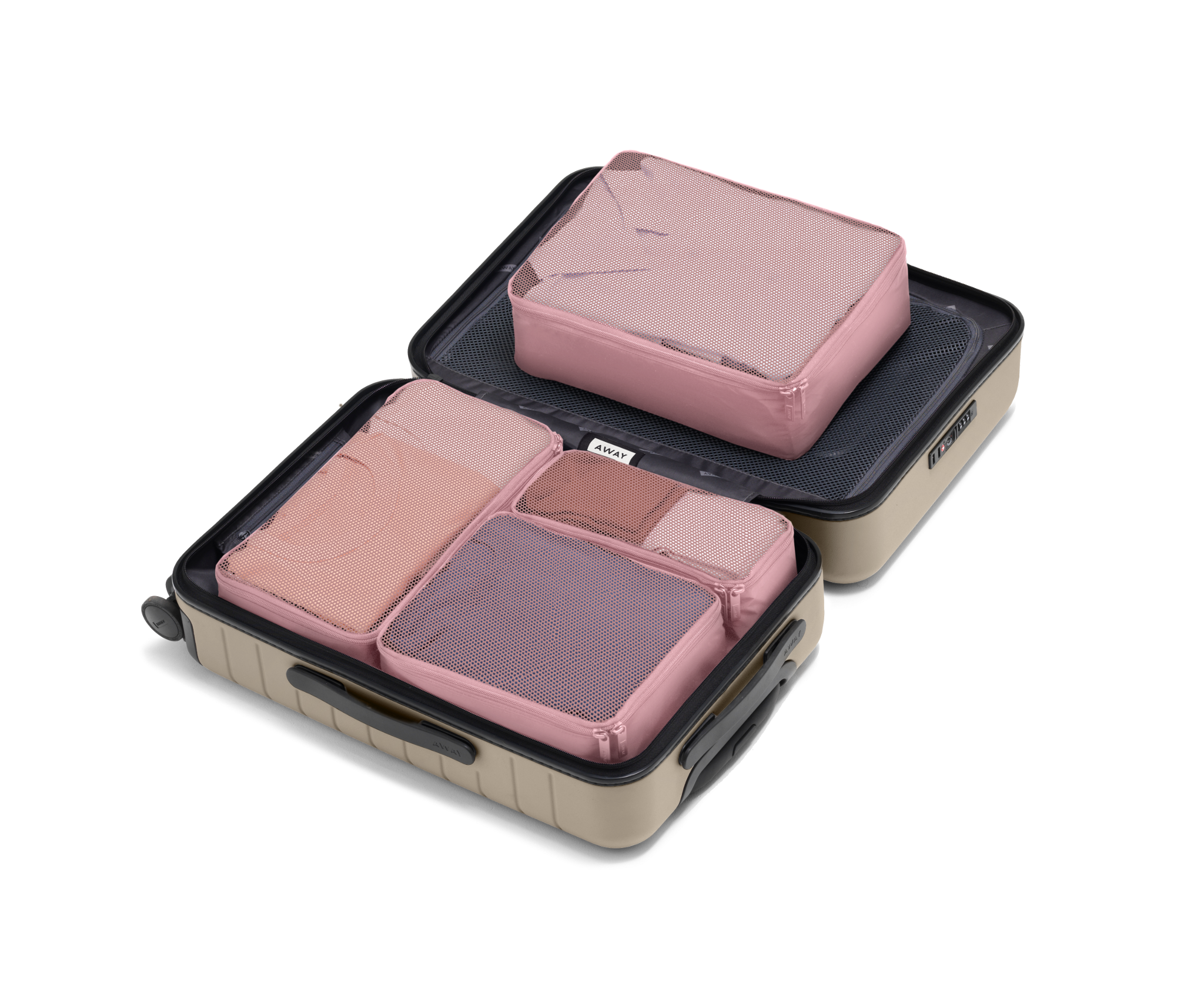 Thrill blush pink packing cubes filled with clothes in muted colors fill a beige Away hard-side carry-on size suitcase against a white background.