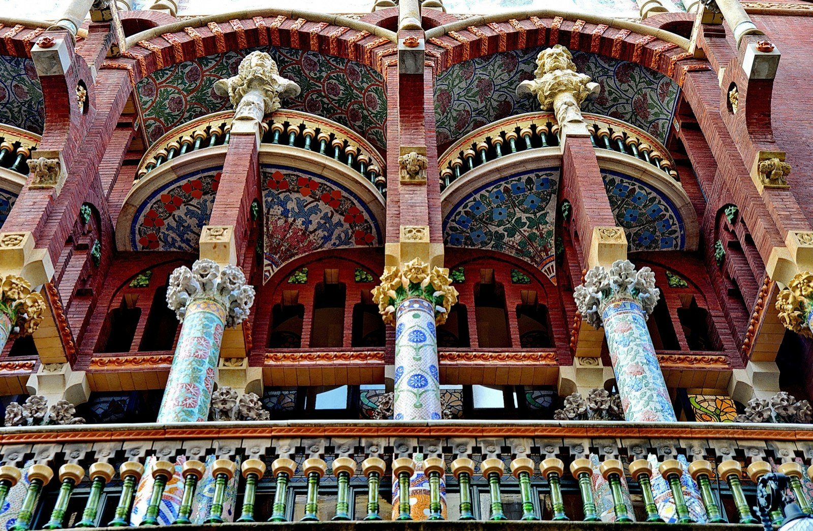 A balcony of the Palau de la Música Catalana decorated with many multi-colored mosaics on the bannisters and columns