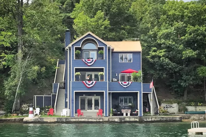 A blue house on a lake