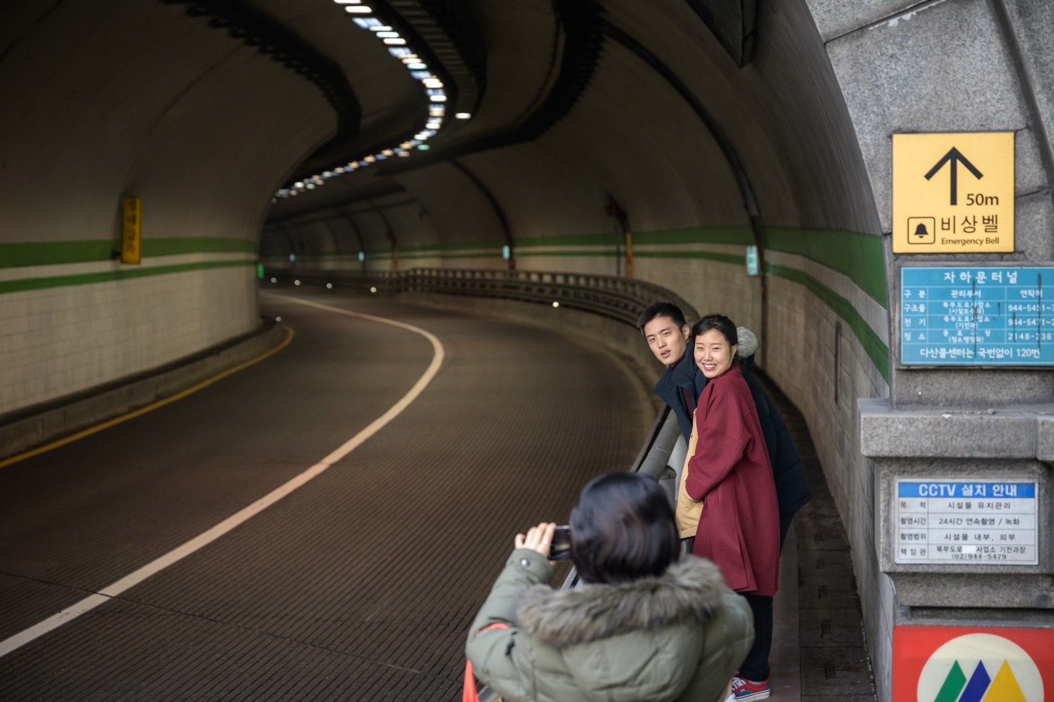 A couple pose for a photo at a tunnel featured in South Korean film Parasite