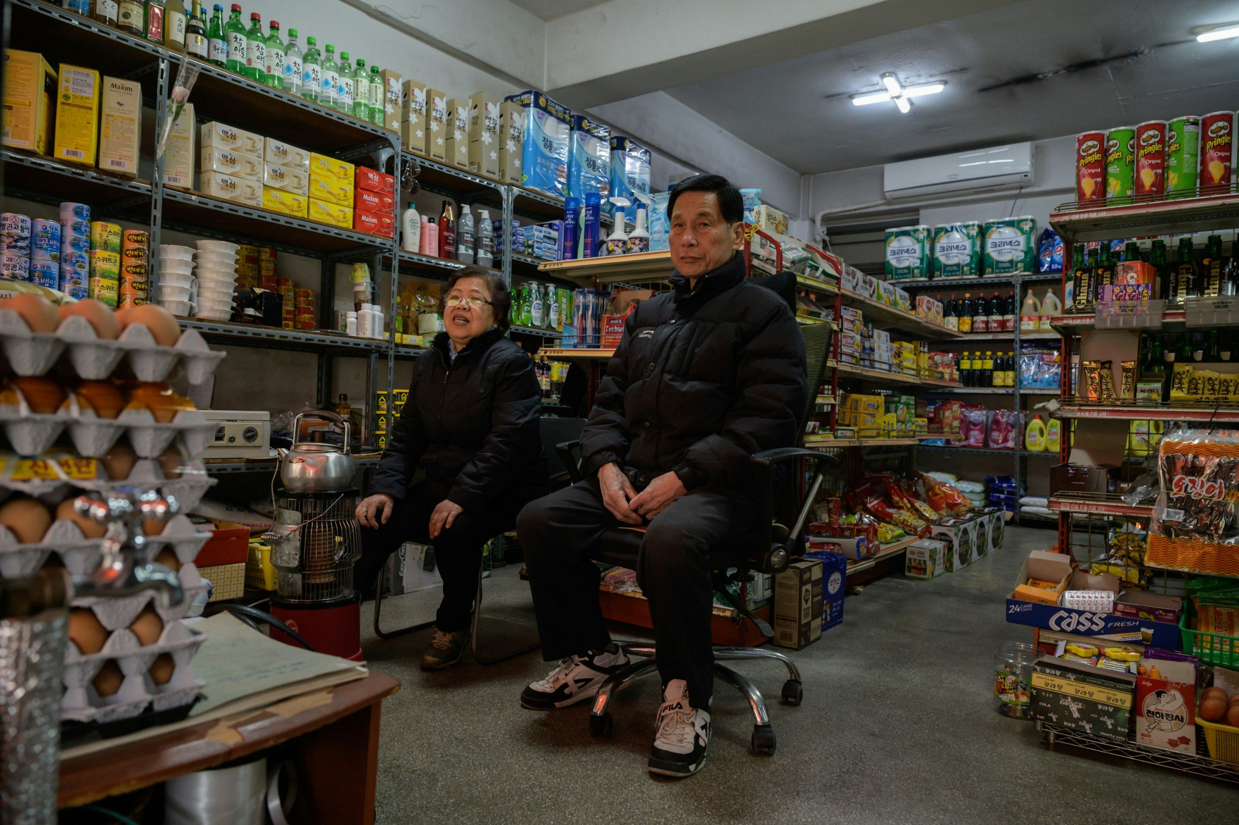 Owner Kim Kyung-soon sits in the Pig Rice Supermarket in Seoul