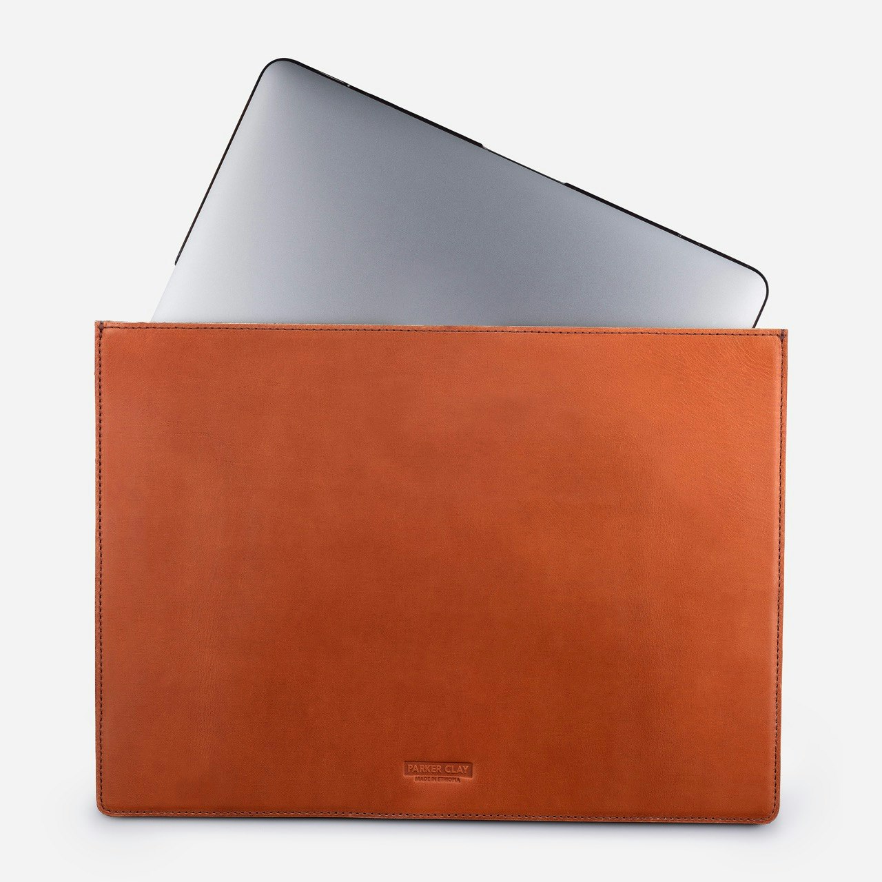 Parker Clay's rust brown Presidio laptop sleeve with a computer sticking out halfway