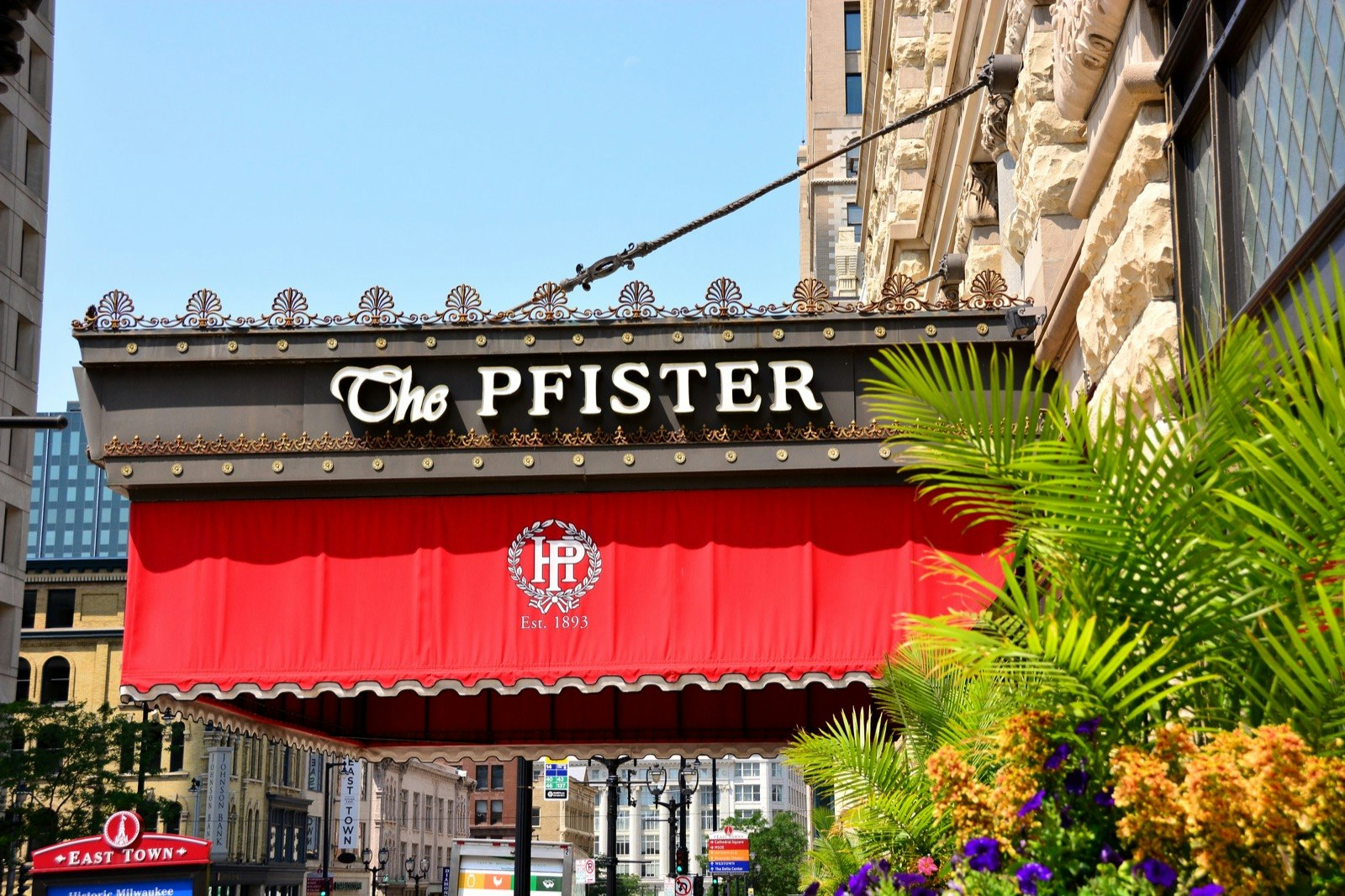 A red awning hangs off the metal marquee that says 'The Pfister'; haunted places world
