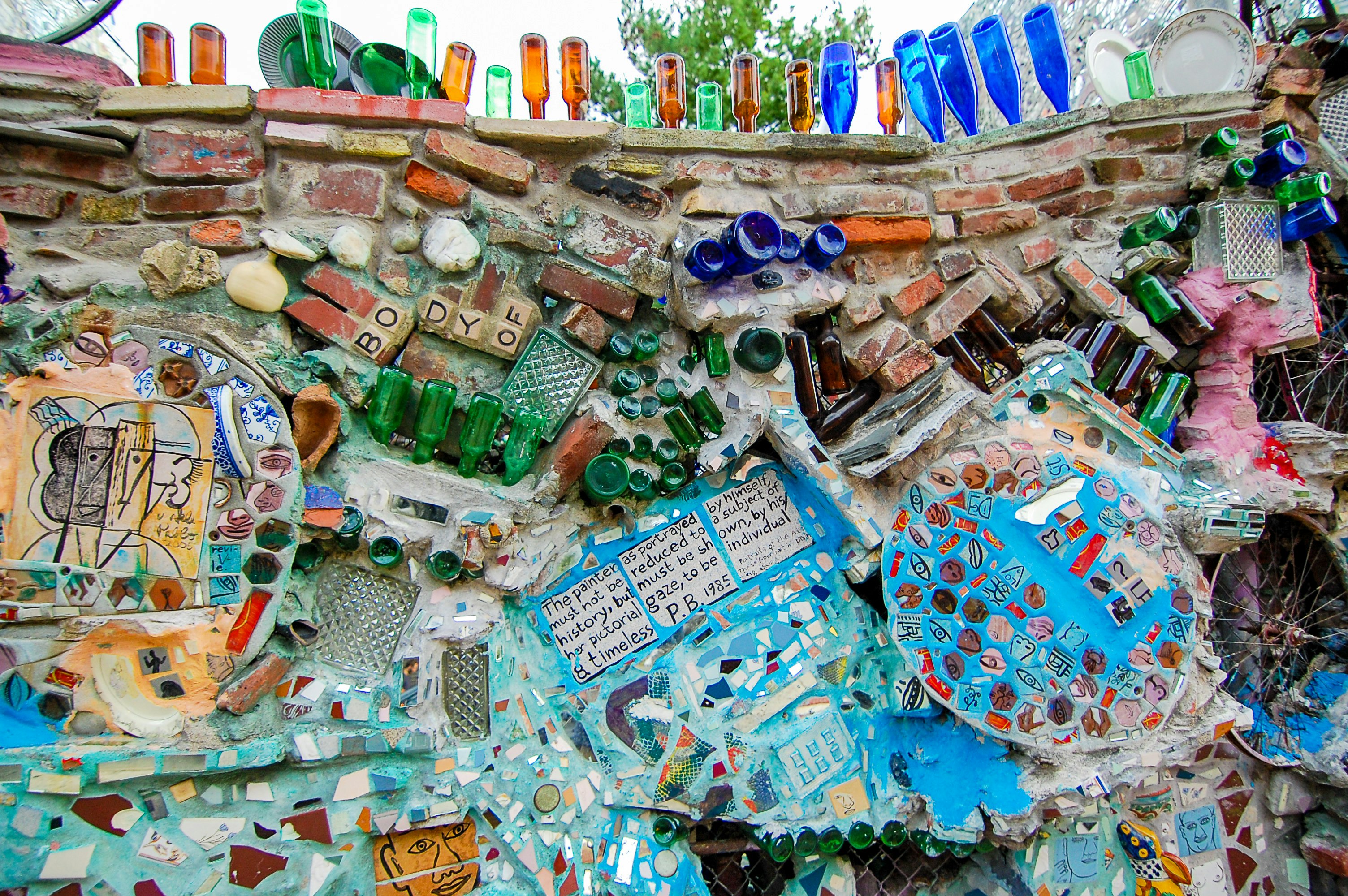 Glass bottles and other ceramics are dug into a wall at Philadelphia’s Magic Gardens
