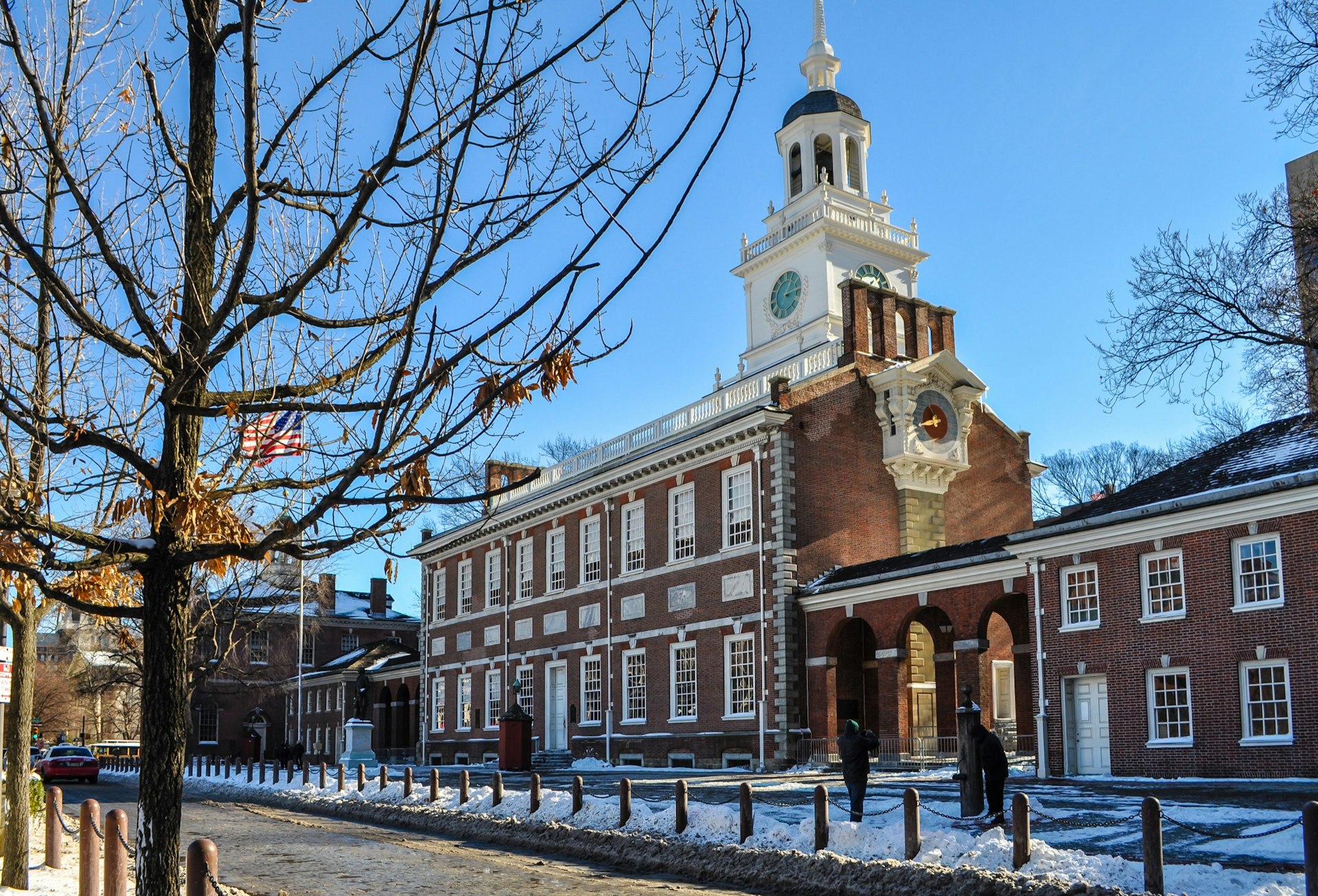 Snow blankets the ground around leafless trees at Independence Hall in Philadelphia