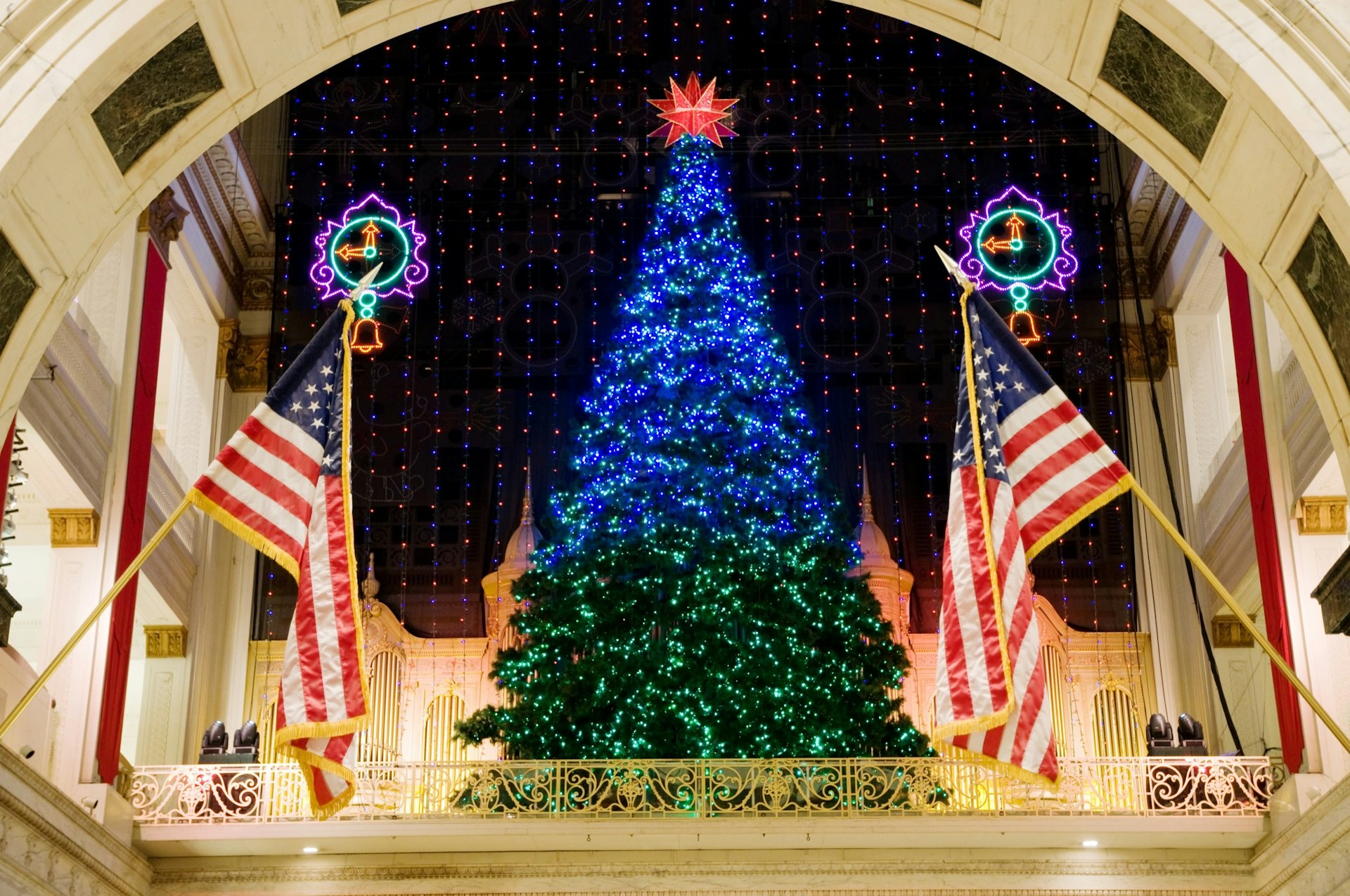 A large Christmas tree stands in front of a tapestry of LED lights in the atrium of a shopping mall in Philadelphia at Christmastime