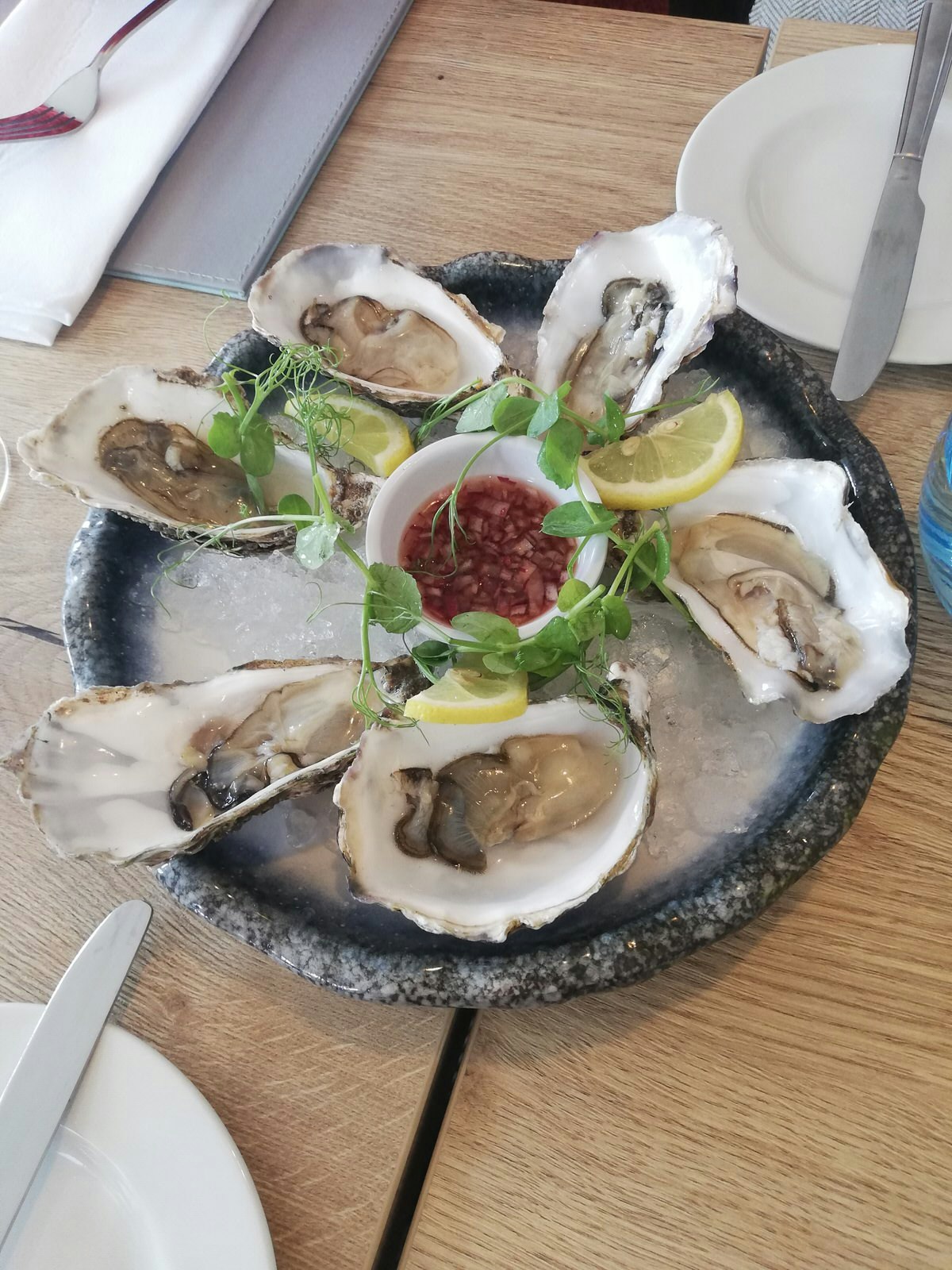 Half a dozen Porlock Bay oysters served on ice with wedges of lime and some chilli