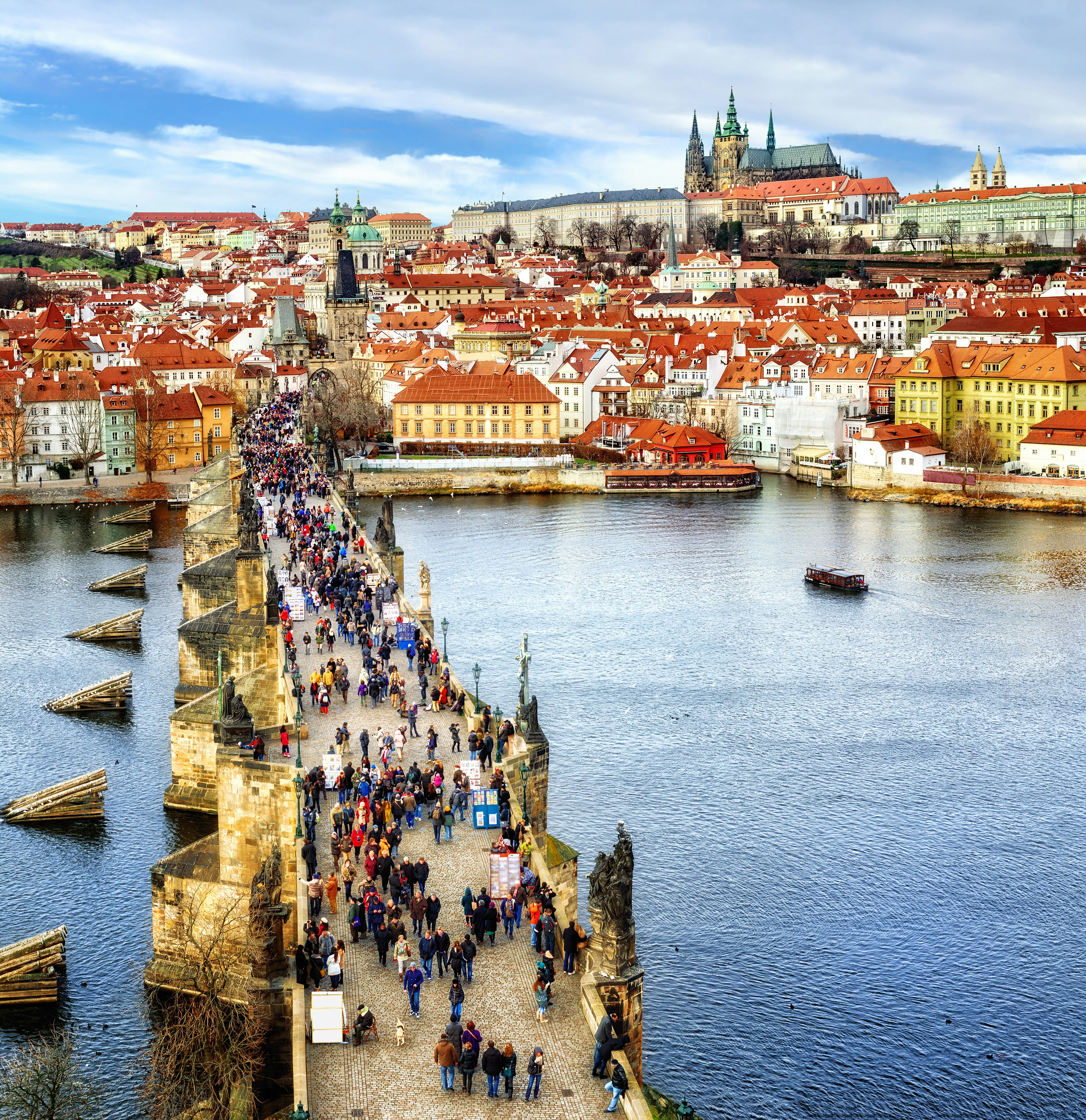 Panorama of Prague with the Castle, Charles Bridge, Vltava river and red roofs of the old town, Czech Republic