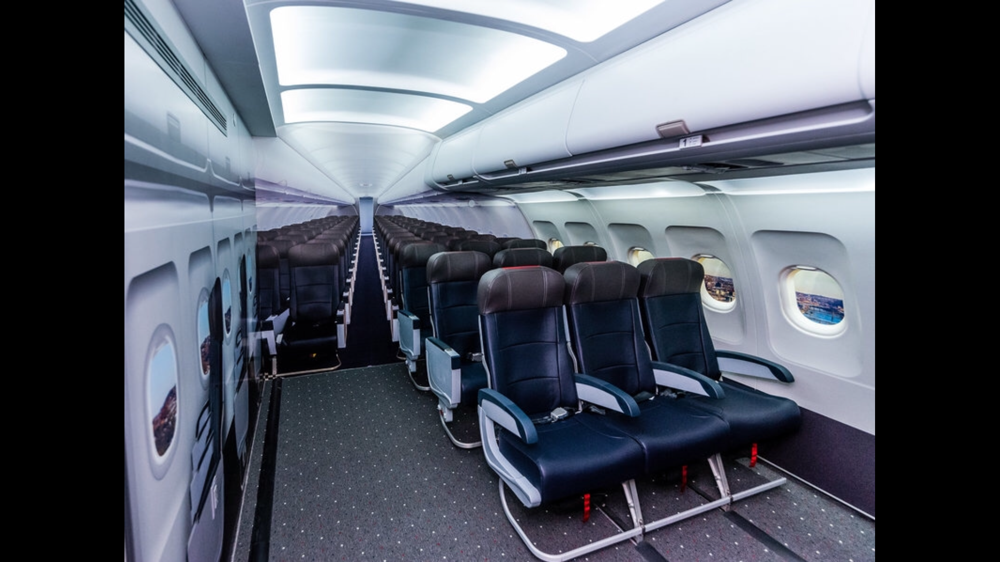 A replica of airplane cabin with seats and fake windows 