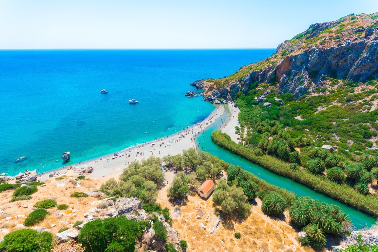 View of Preveli beach at the Libyan Sea, with a river and palm forest, in southern Crete, Greece.