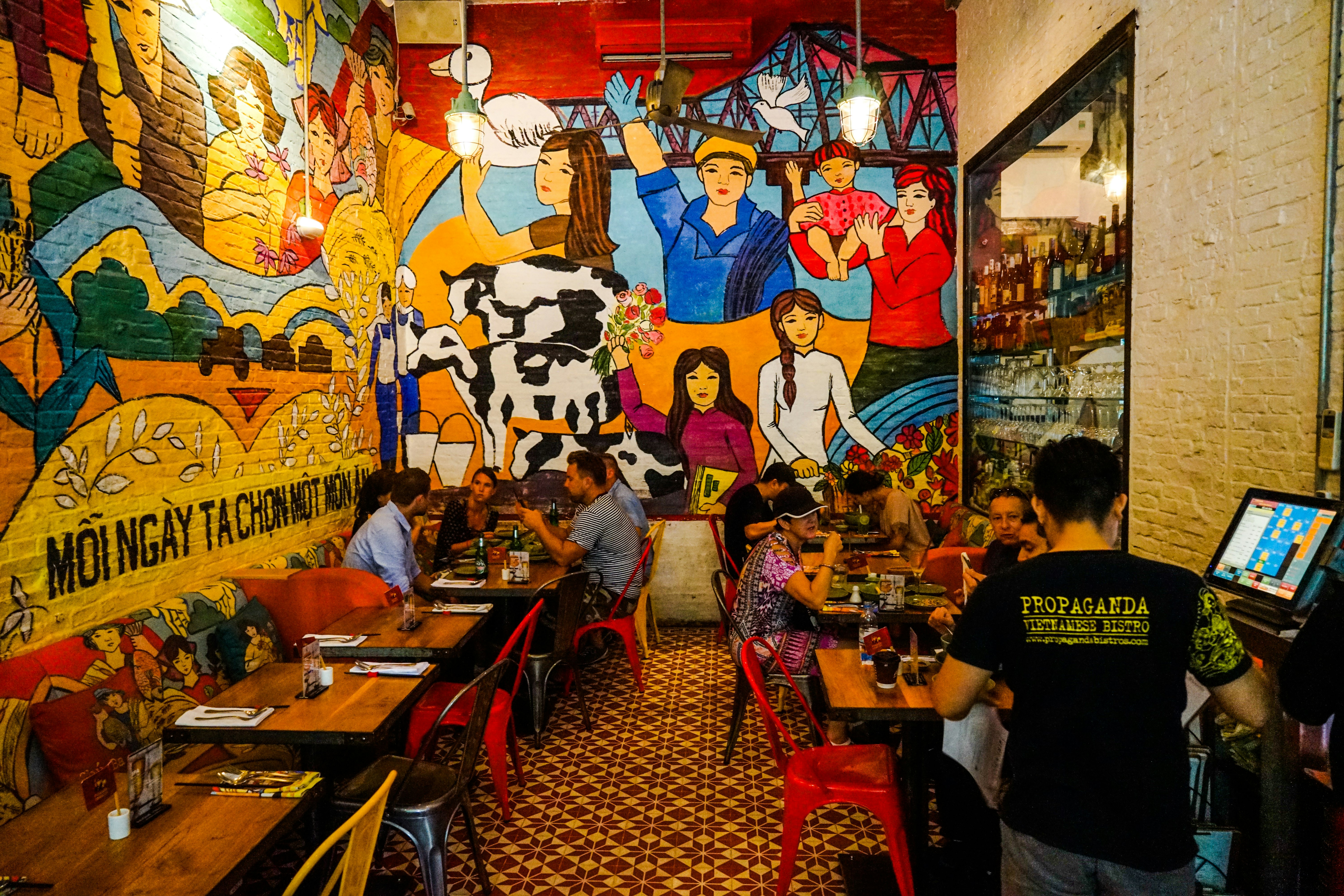 Brightly-colored murals are etched on the walls of Propaganda Bistro Ho Chi Minh City