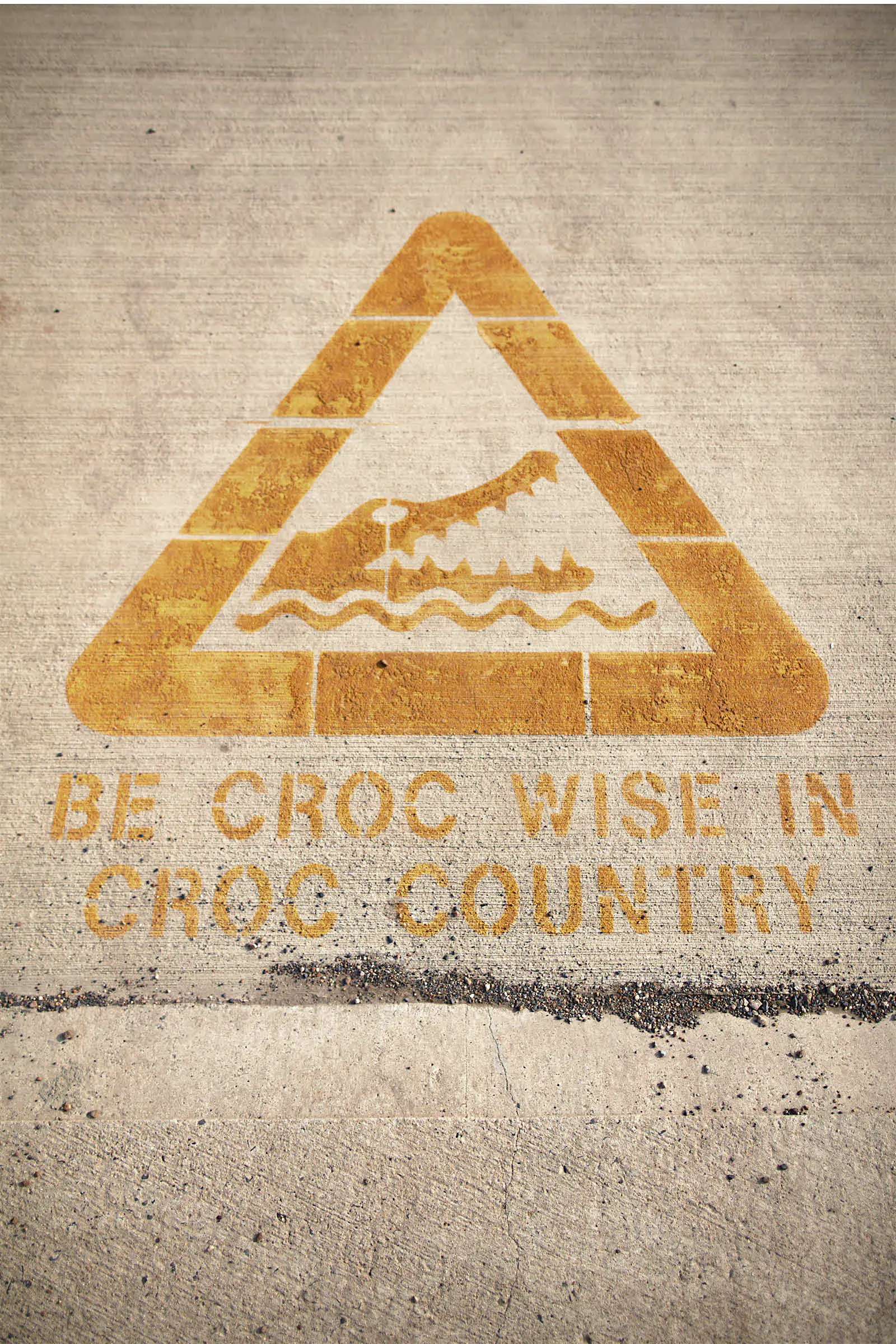 Crocodile warning Queensland Australia A crocodile warning sign stencilled on a pavement