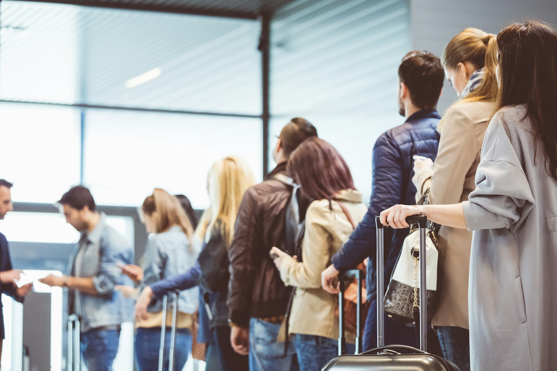 A line forms to board an airplane; frequent fliers' final call secrets