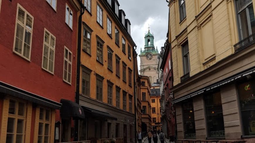 A narrow street between historic buildings with only a couple of people in Stockholm, Sweden; Quiet parks