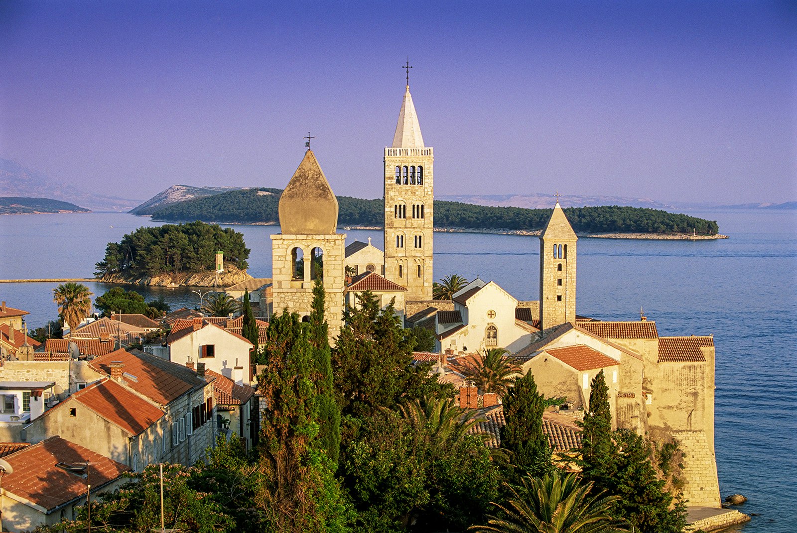 The historic spires of Rab at sunset, backed by the Kvarner Gulf.