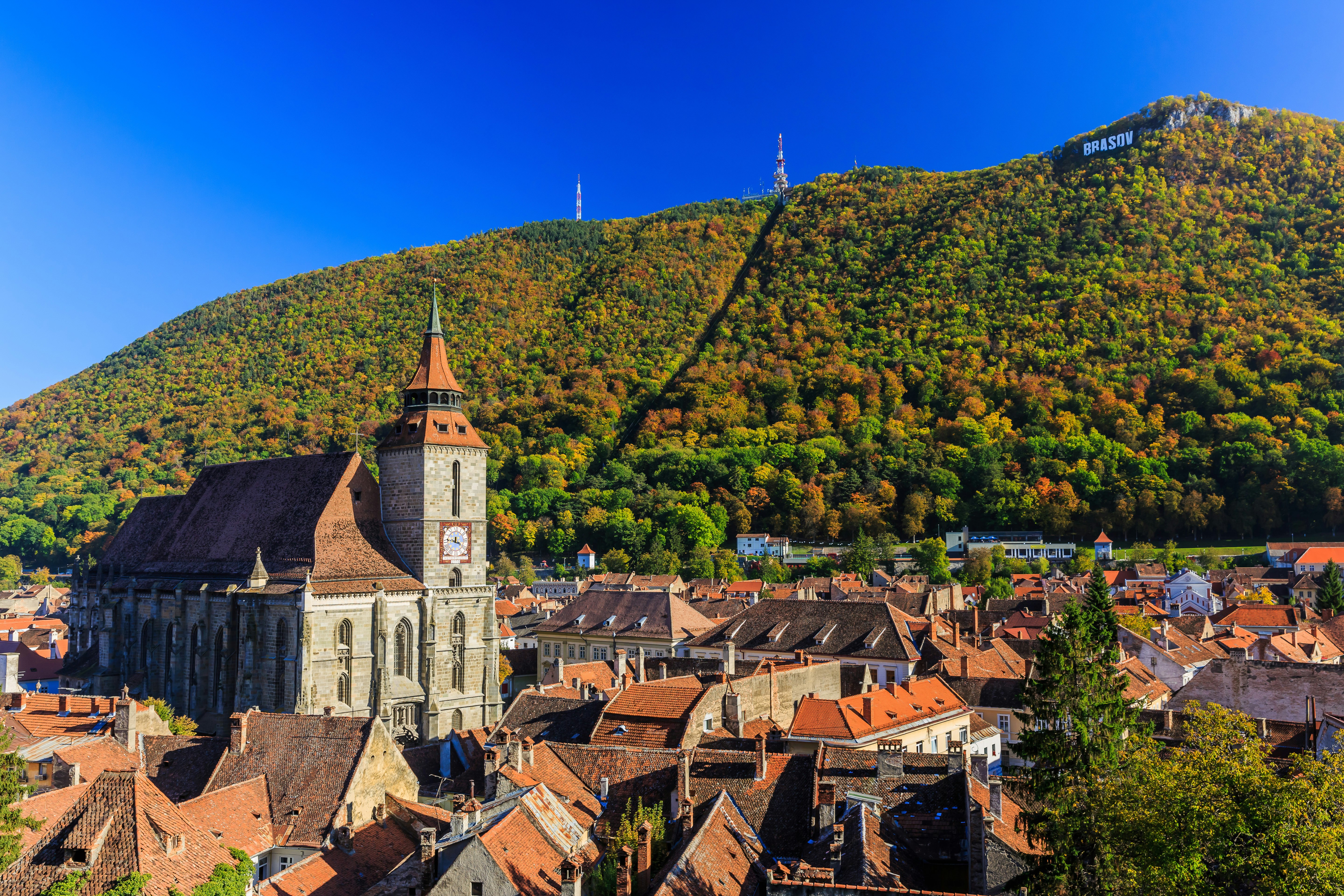Brasov and its most important landmark, the Black Church towers over the old town. Transylvania, Romania.