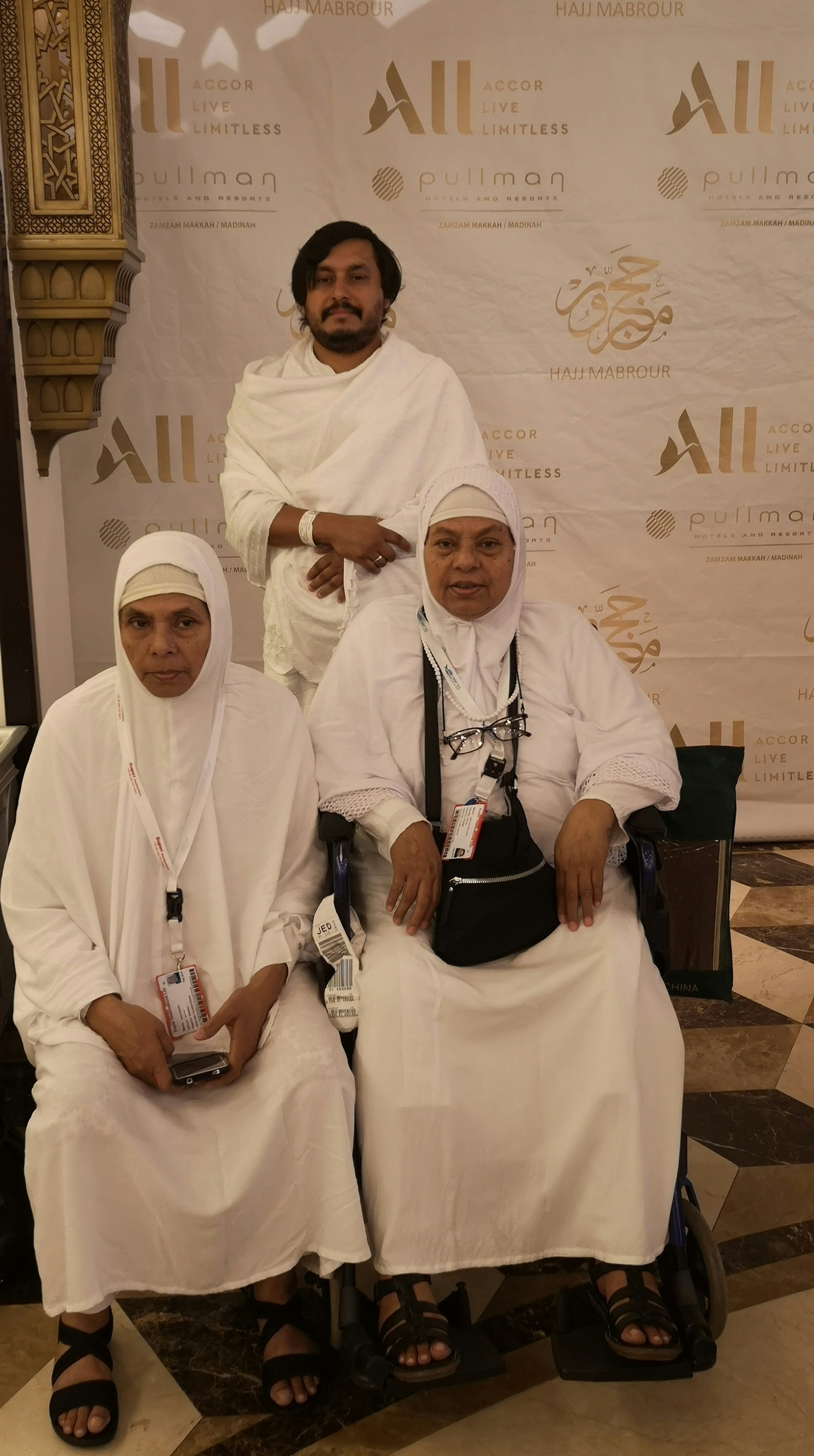 Tharik stands behind his mother and aunt in white as they all prepare to commence the Hajj.