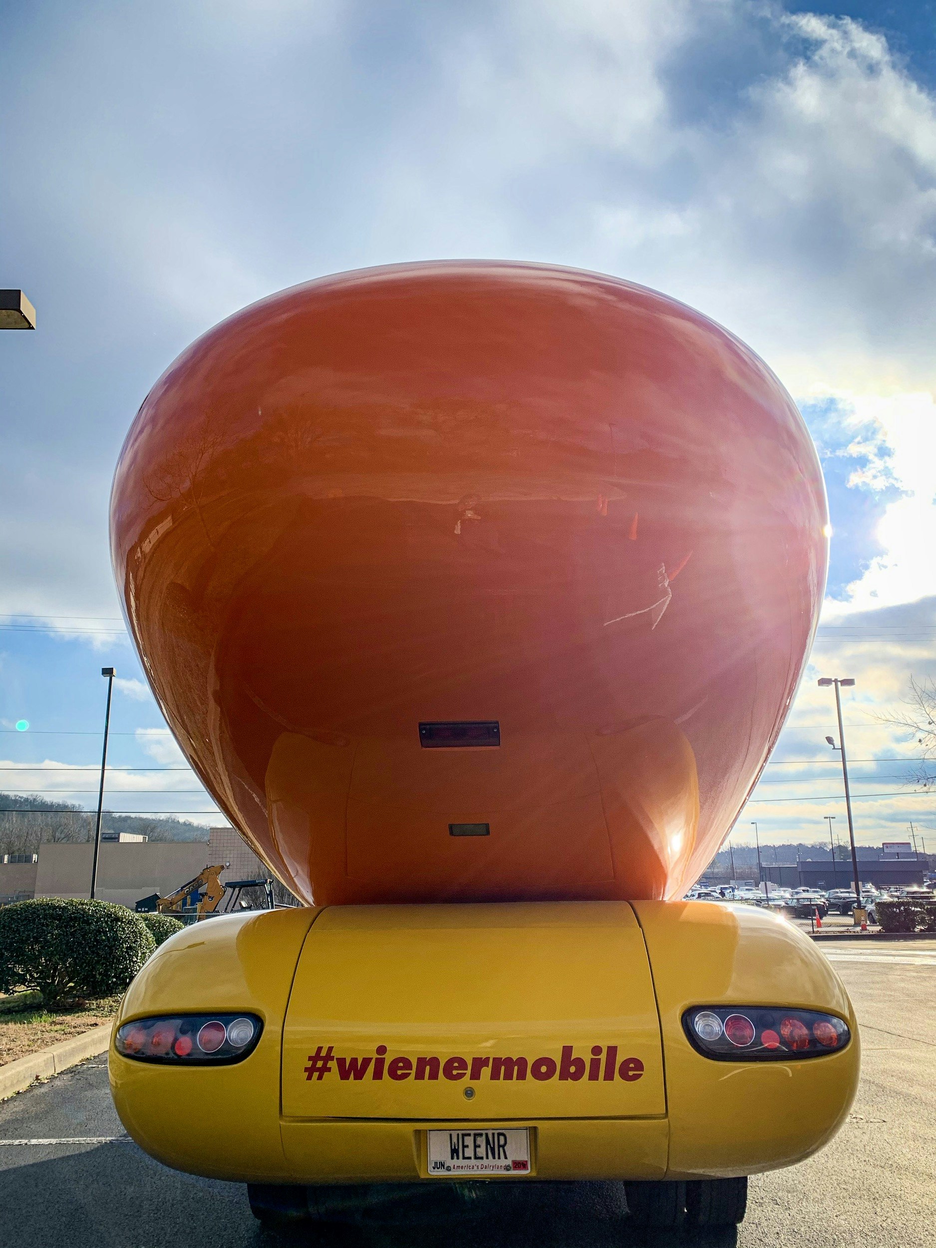 Looking at the back of the Oscar Mayer Wienermobile, the license plate reads 'WEENR"
