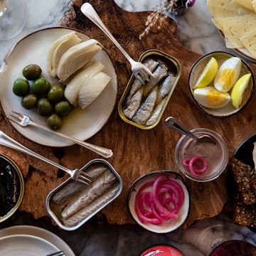 A table filled with food in tins and on plates at Rhodora