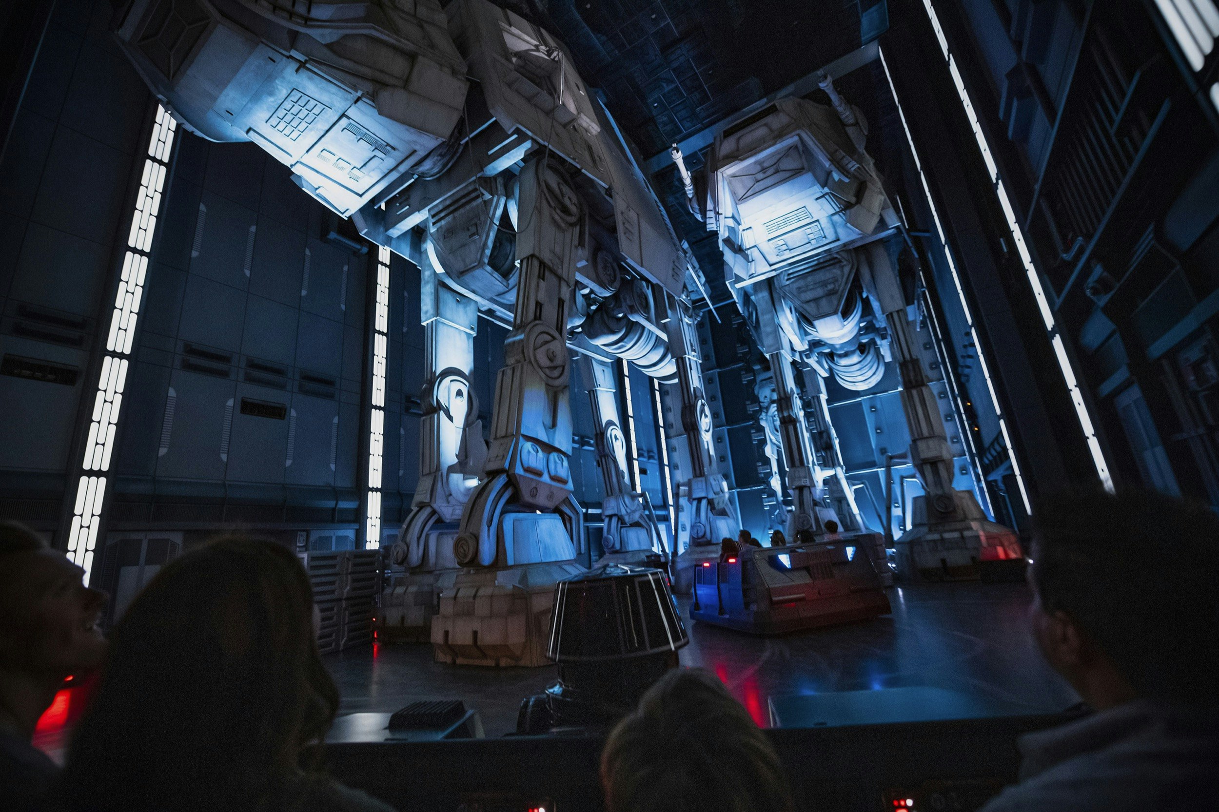 Guests race past massive AT-AT walkers aboard a First Order Star Destroyer as part of Star Wars: Rise of the Resistance 