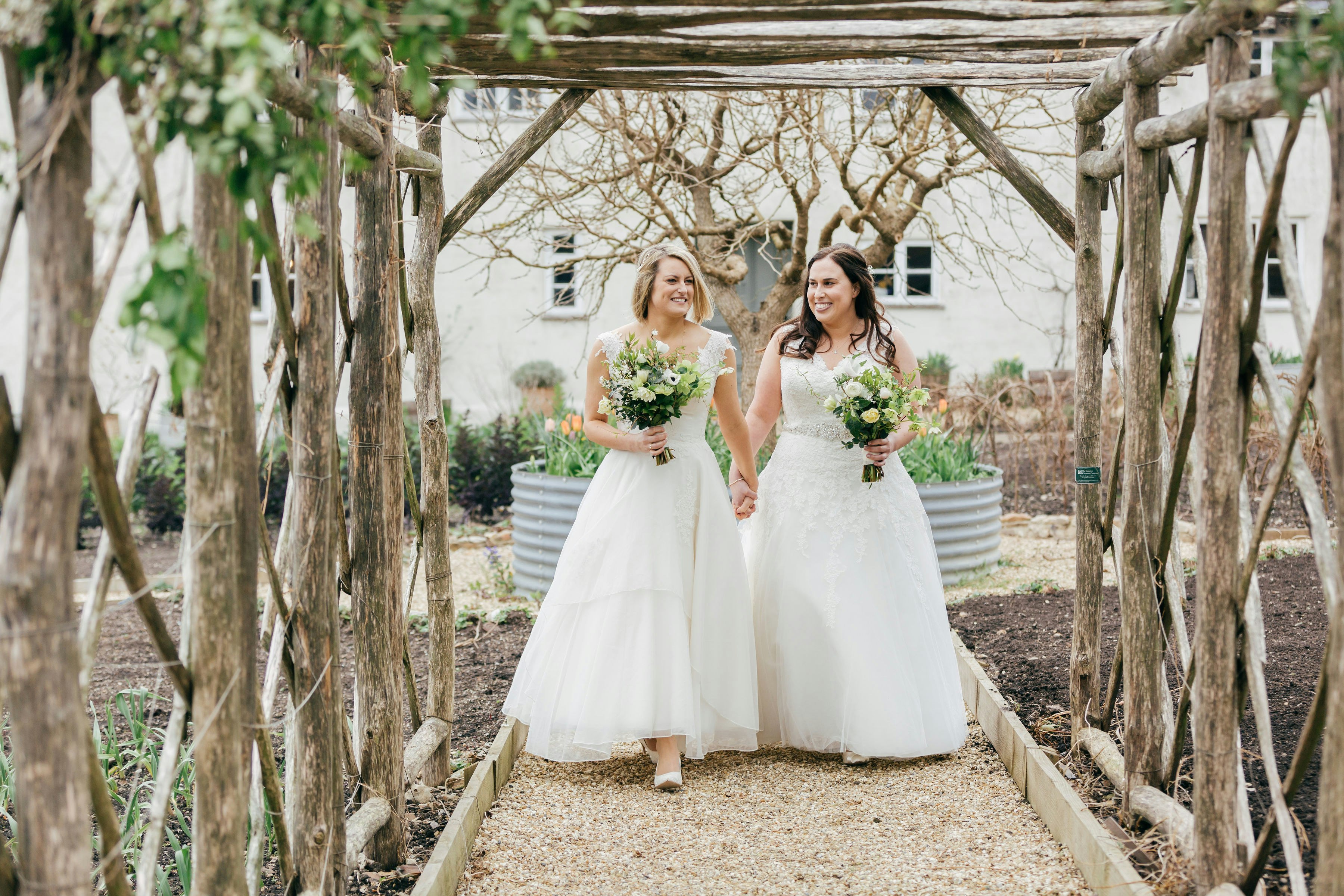 Two brides walk up the aisle at River Cottage, Devon/Dorset