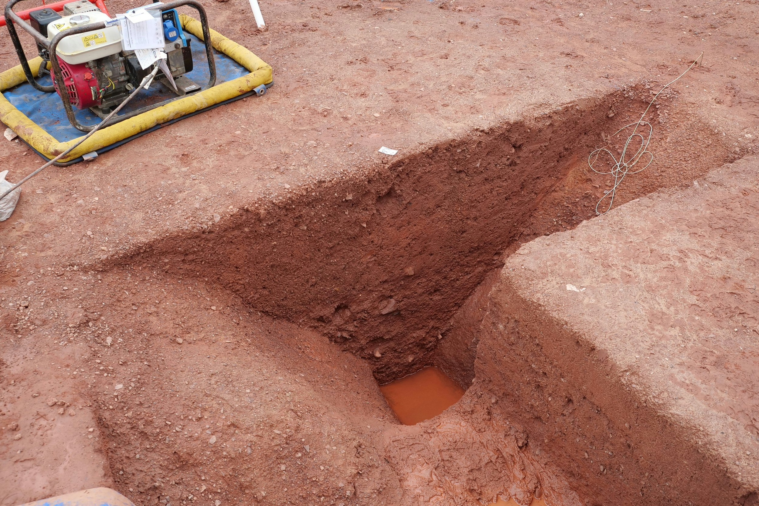 A trench dug in the ground that exposes a Roman fort