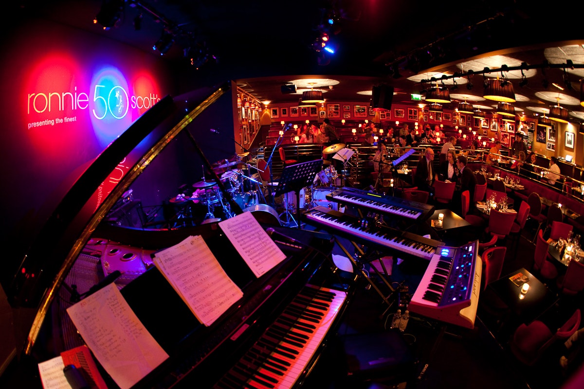 Keyboards and other instruments on the stage in the basement interior of Ronnie Scott's in London.