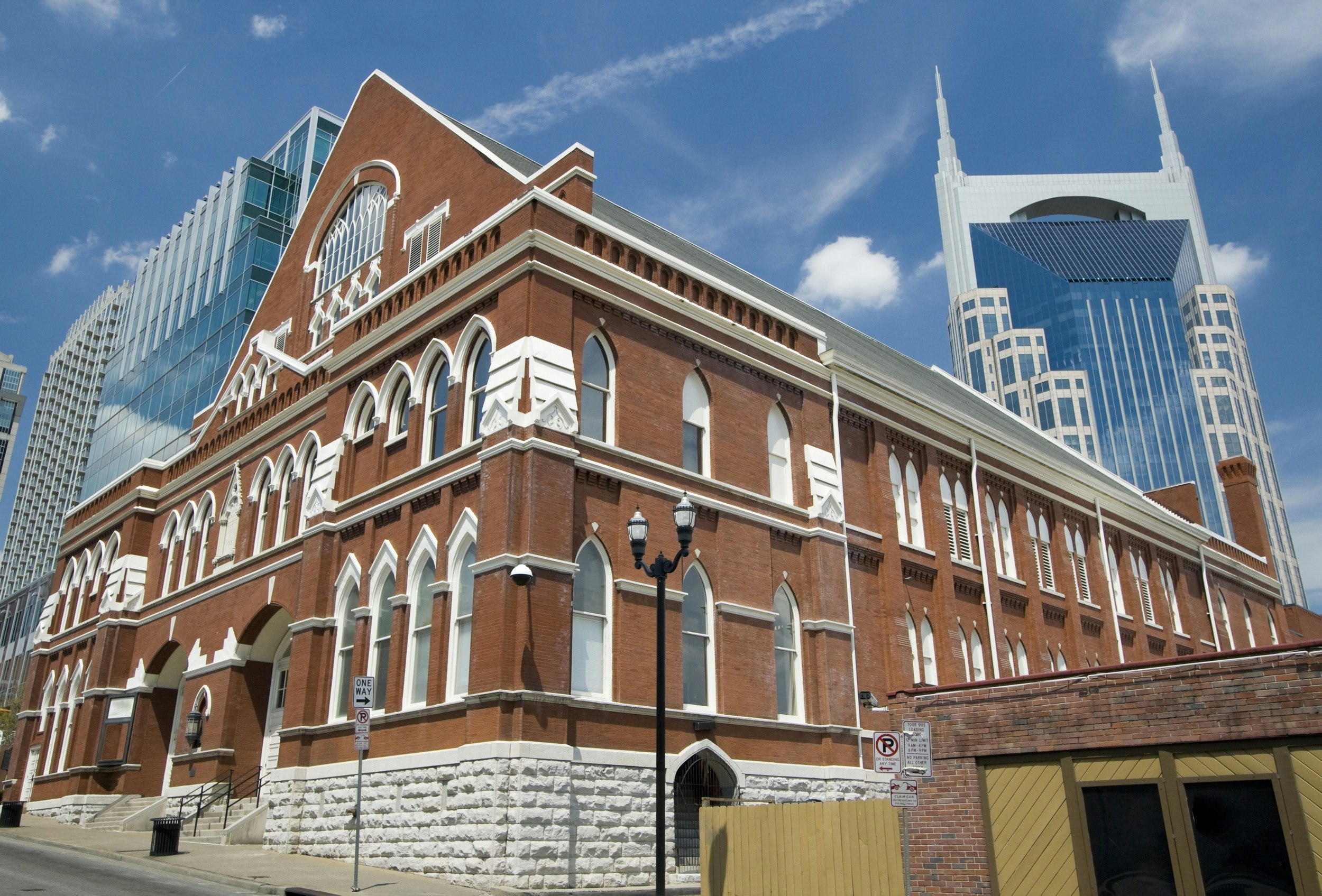 The Ryman Auditorium is seen against a brilliant blue sky; best places in Nashville for country music