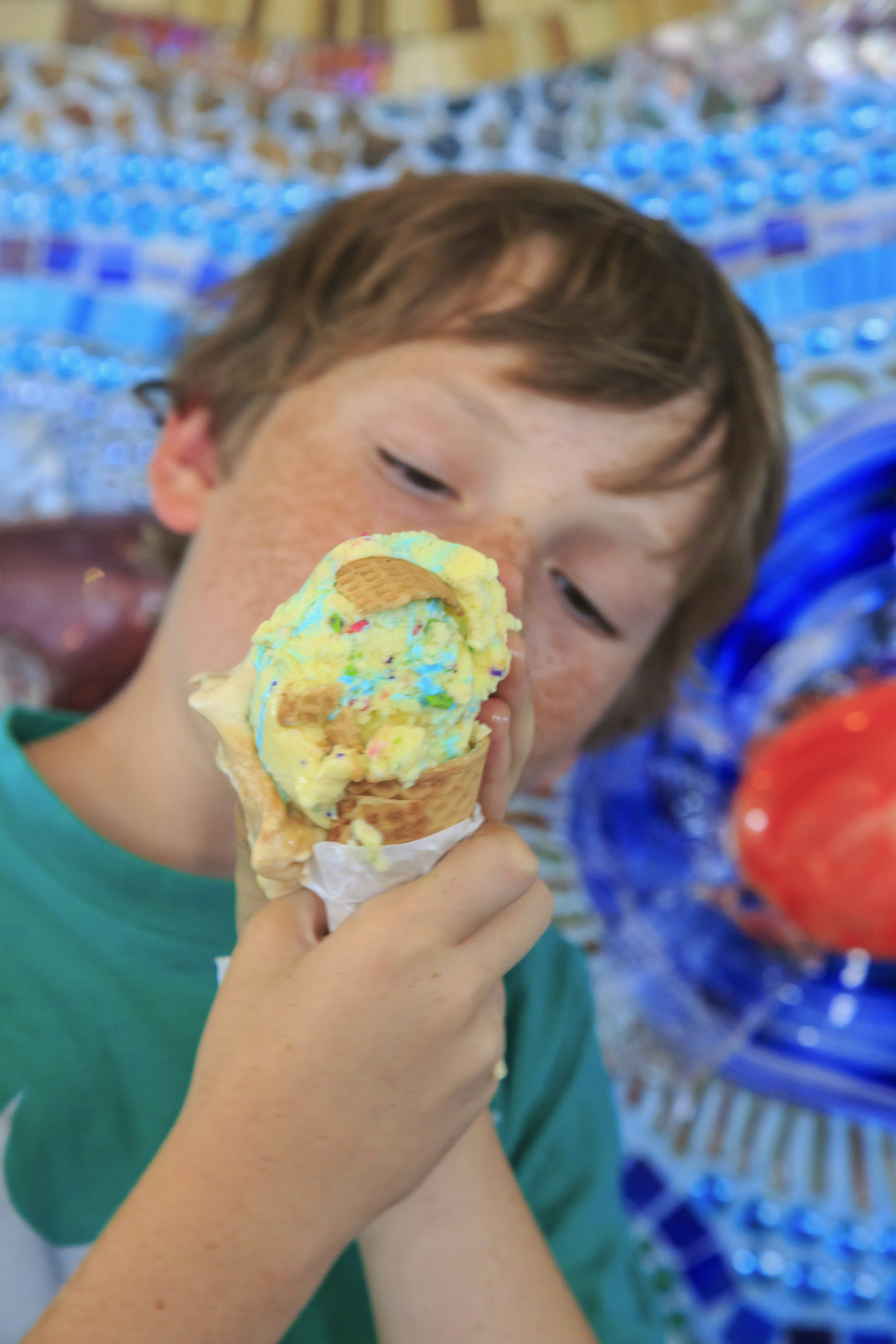 A freckled boy eats an ice cream cone at Pacific Beach in San Diego; California ice cream