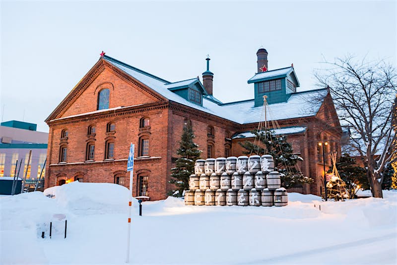 Sapporo Biergarten Sapporo Biergarten in Hokkaido, housed in an old brick factory surrounded by snow, with snow-dusted beer barrels outside.