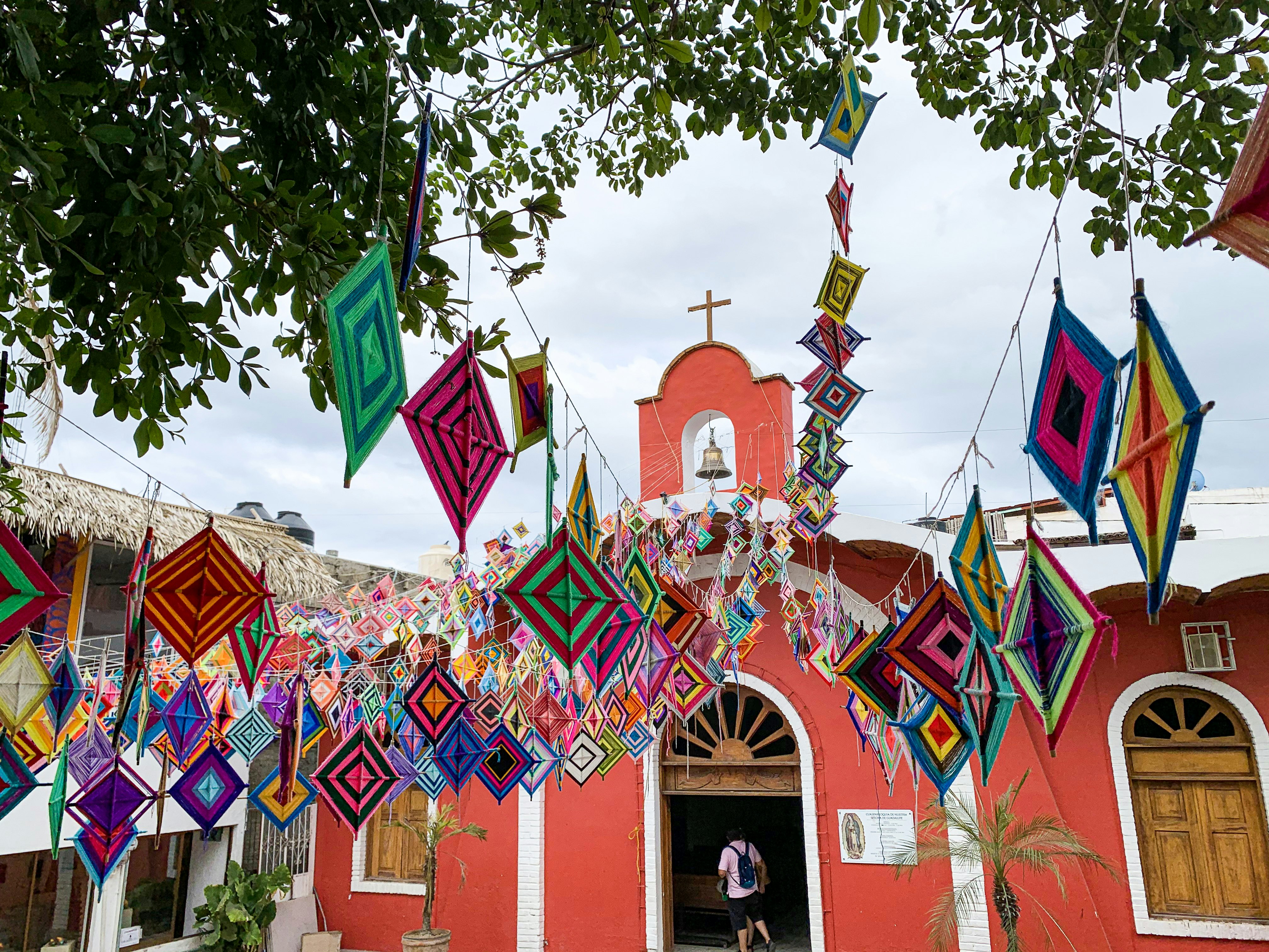 Woven Ojo de Dios strung up outside a colorful church