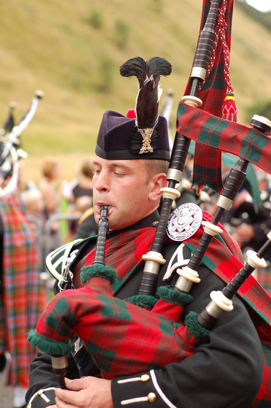 A bagpiper wearing traditional scottish tartans 