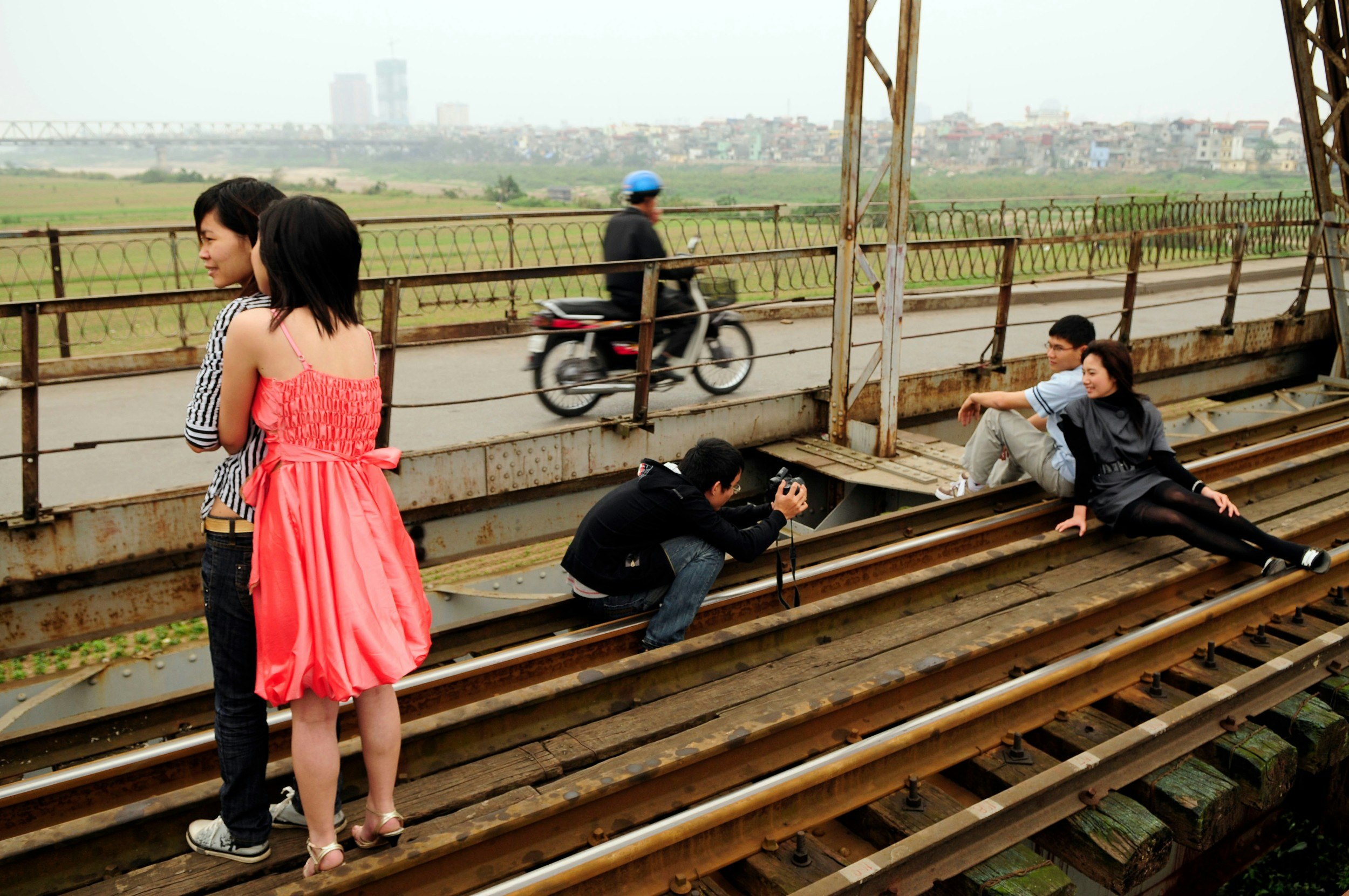 People posing for selfies on Long Bien Bridge in Hanoi