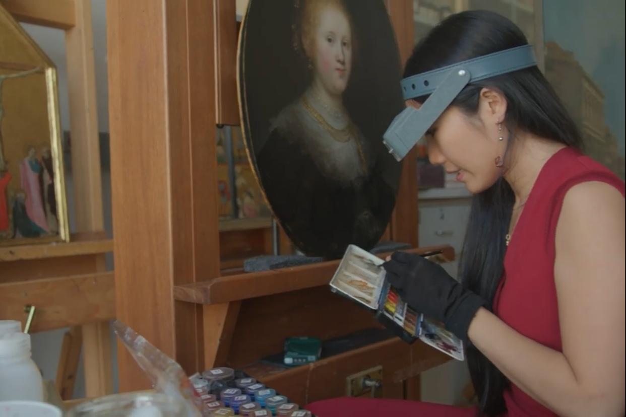 Conservator Shan Kuang working on Portrait of a Young Woman