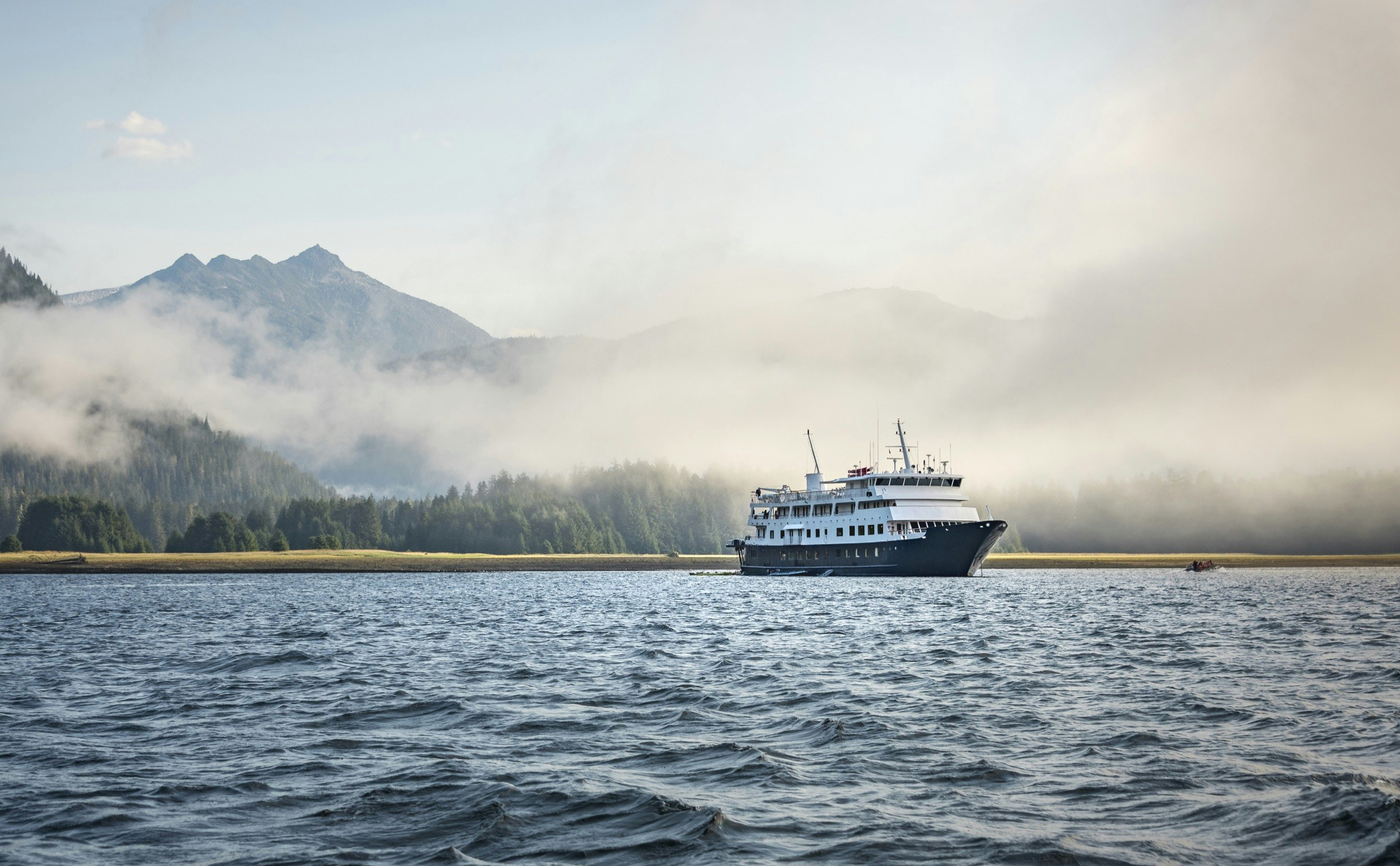 A small cruise ship slips through fog on a trip off the coast of Alaska; alternative ways to explore Alaska