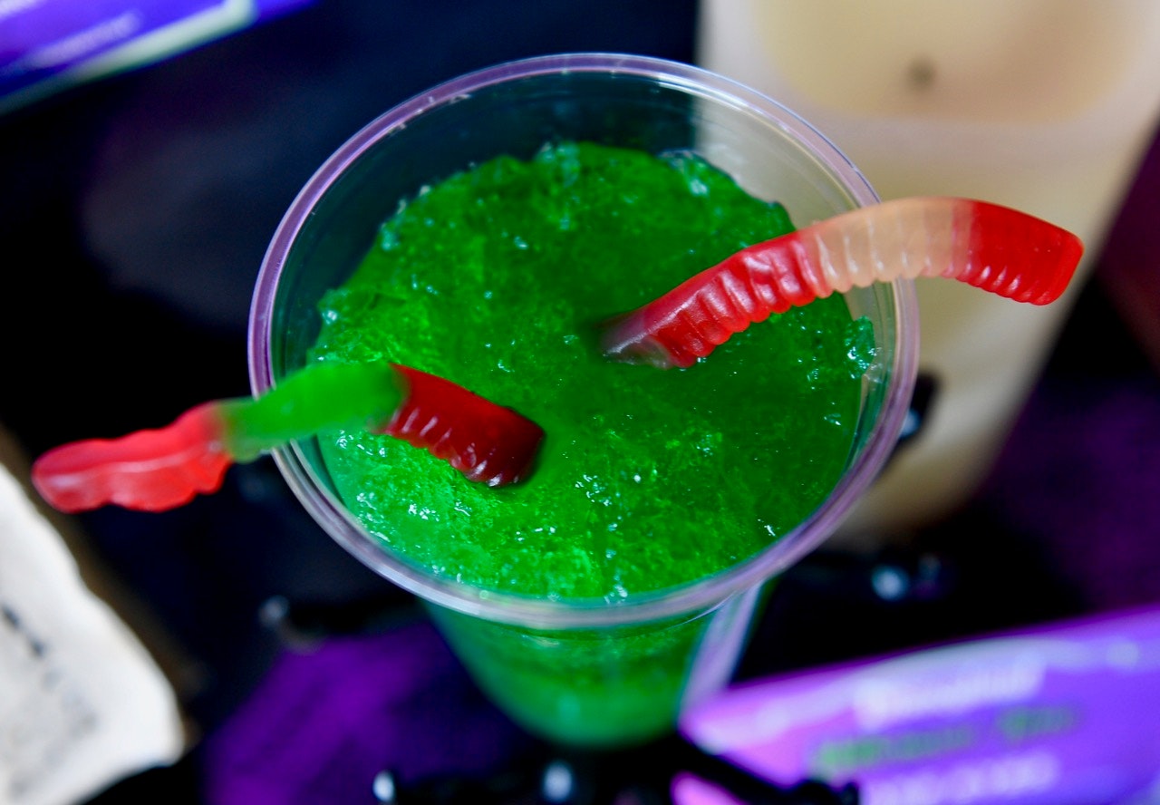 Snake Eyes - midori-limeade slush, gummy worms and dice glow cubes available at the Hollywood Land Lounge inside California Adventure in Anaheim, CA