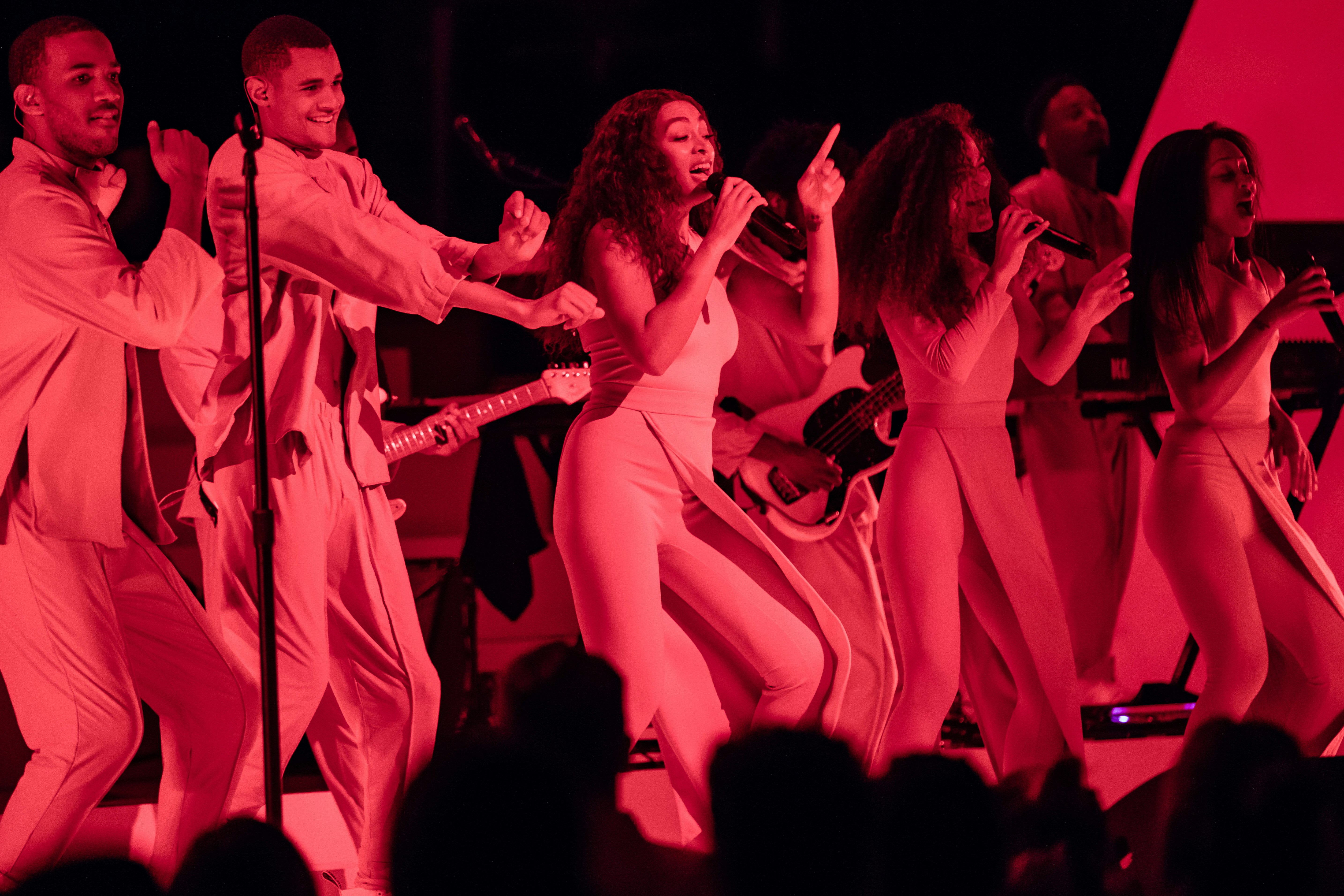Solange on stage with dancers and red lighting