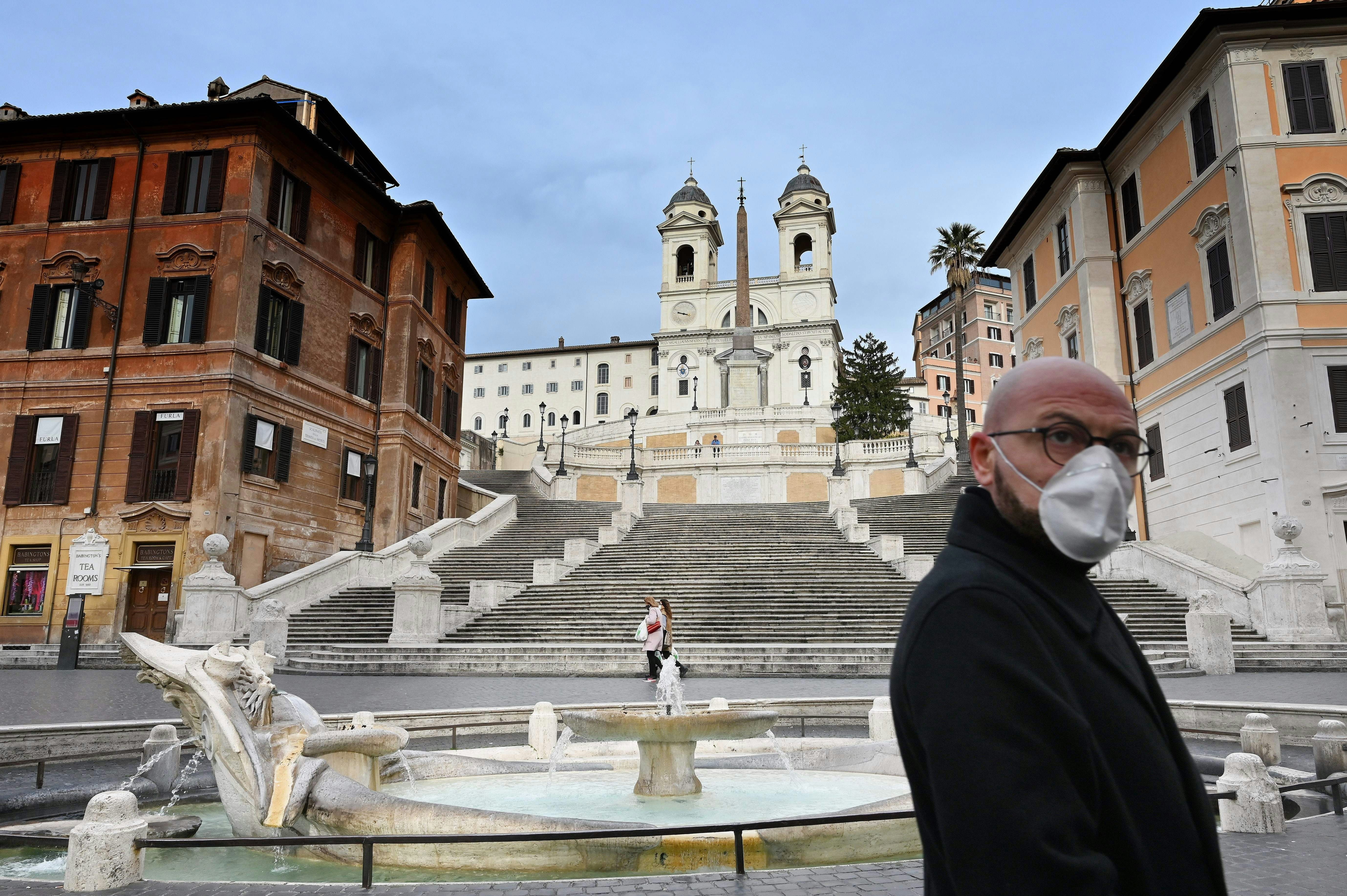 A man in a face mask walks past the Spanish Steps in Rome during the coronavirus lockdown in Italy.