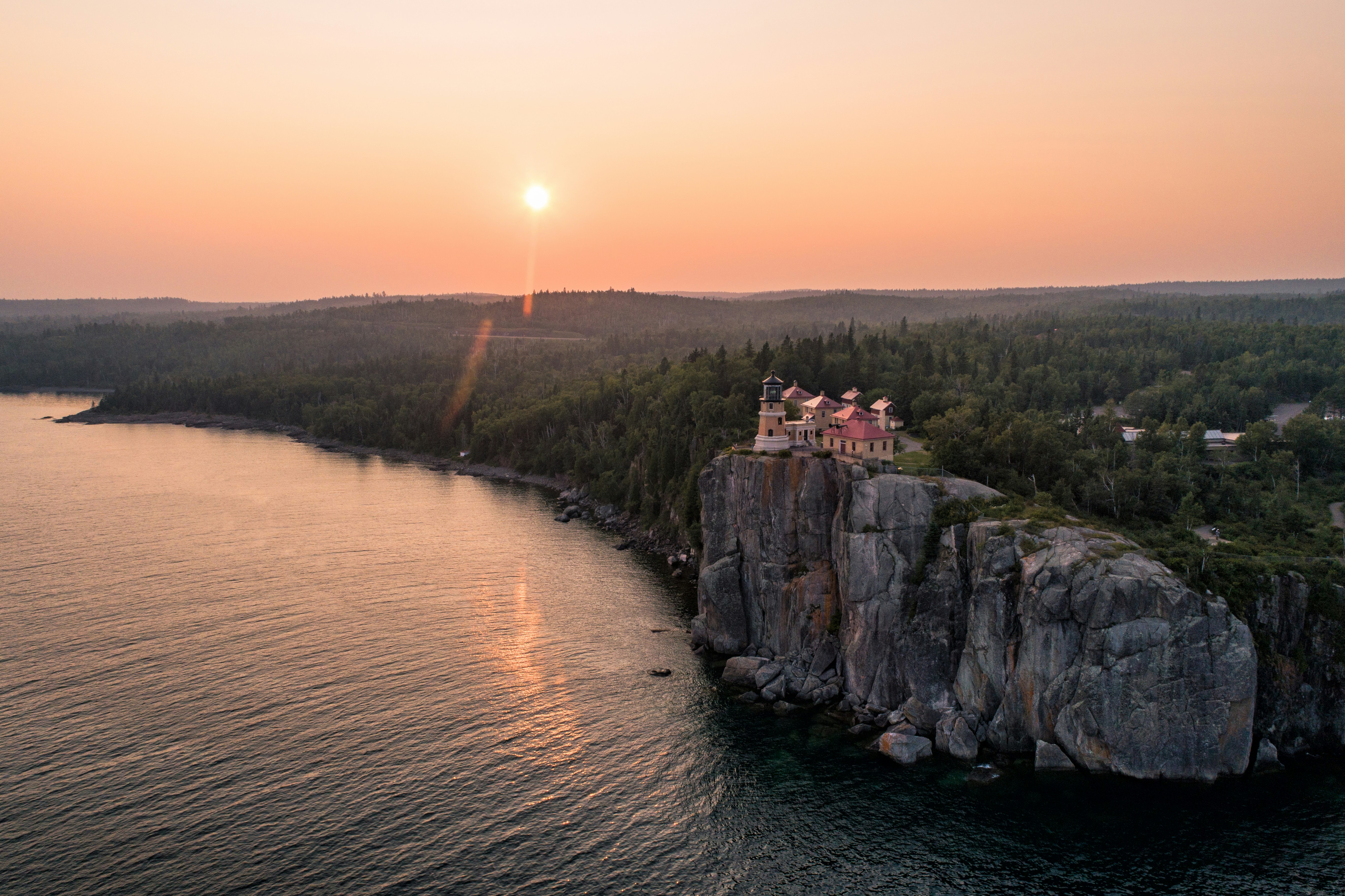 A sunset view of Split Rock Lighthouse from high above the water of Lake Superior