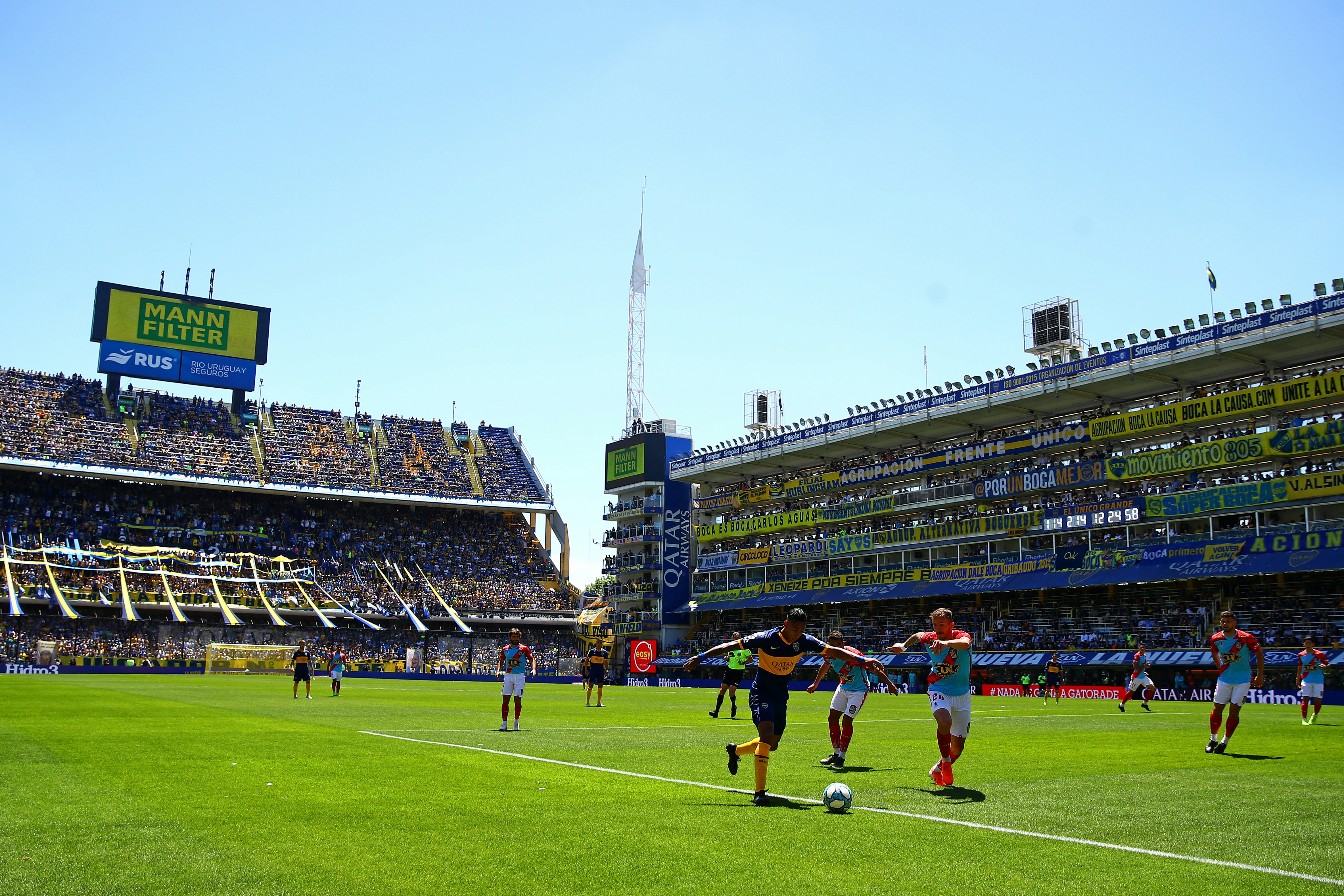 Sporting fans watch two football teams compete at La Bombonera in Buenos Aires