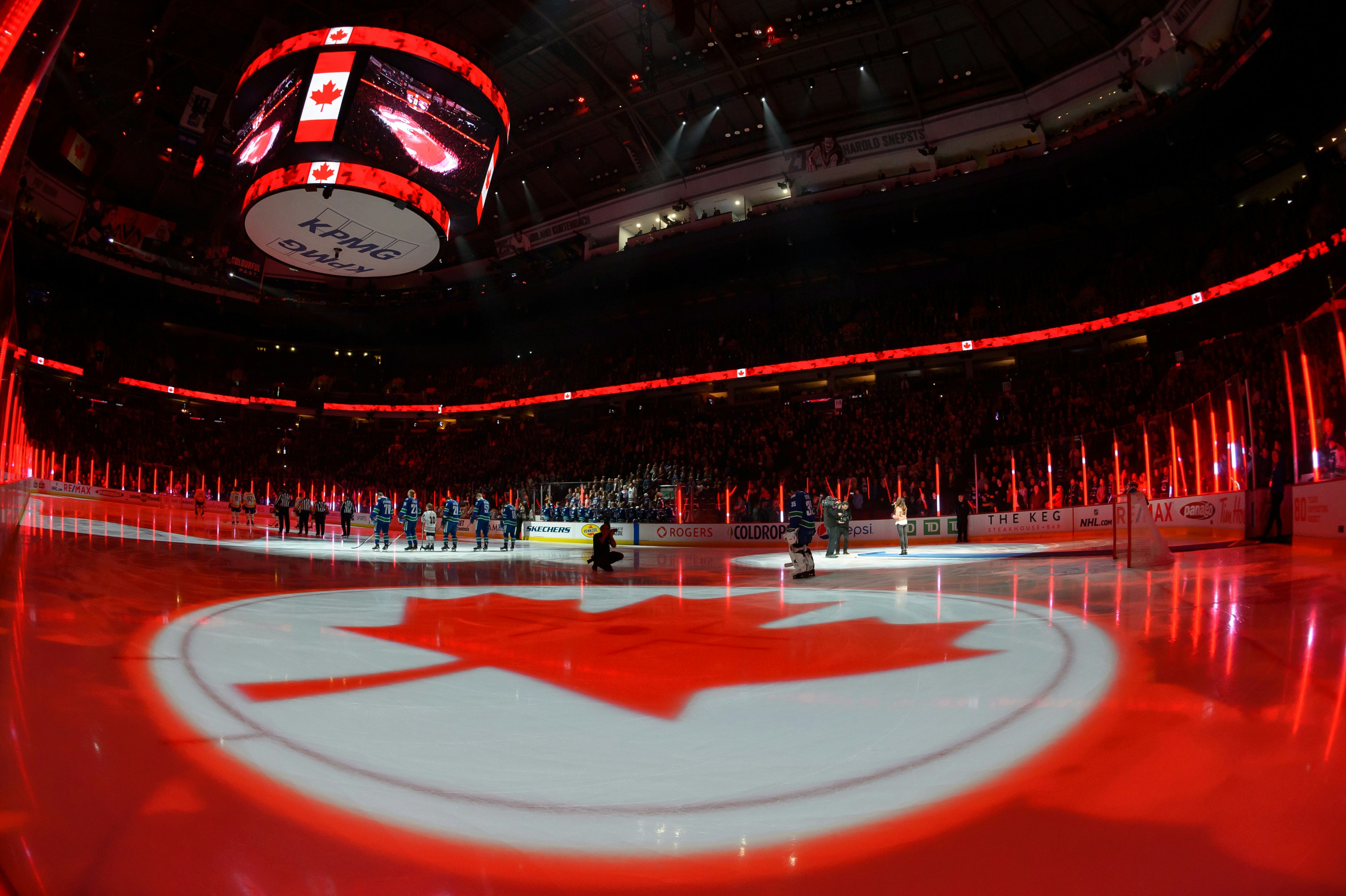 A light show depicting the Canadian flag lights up Rogers Arena in Vancouver before an ice hockey match