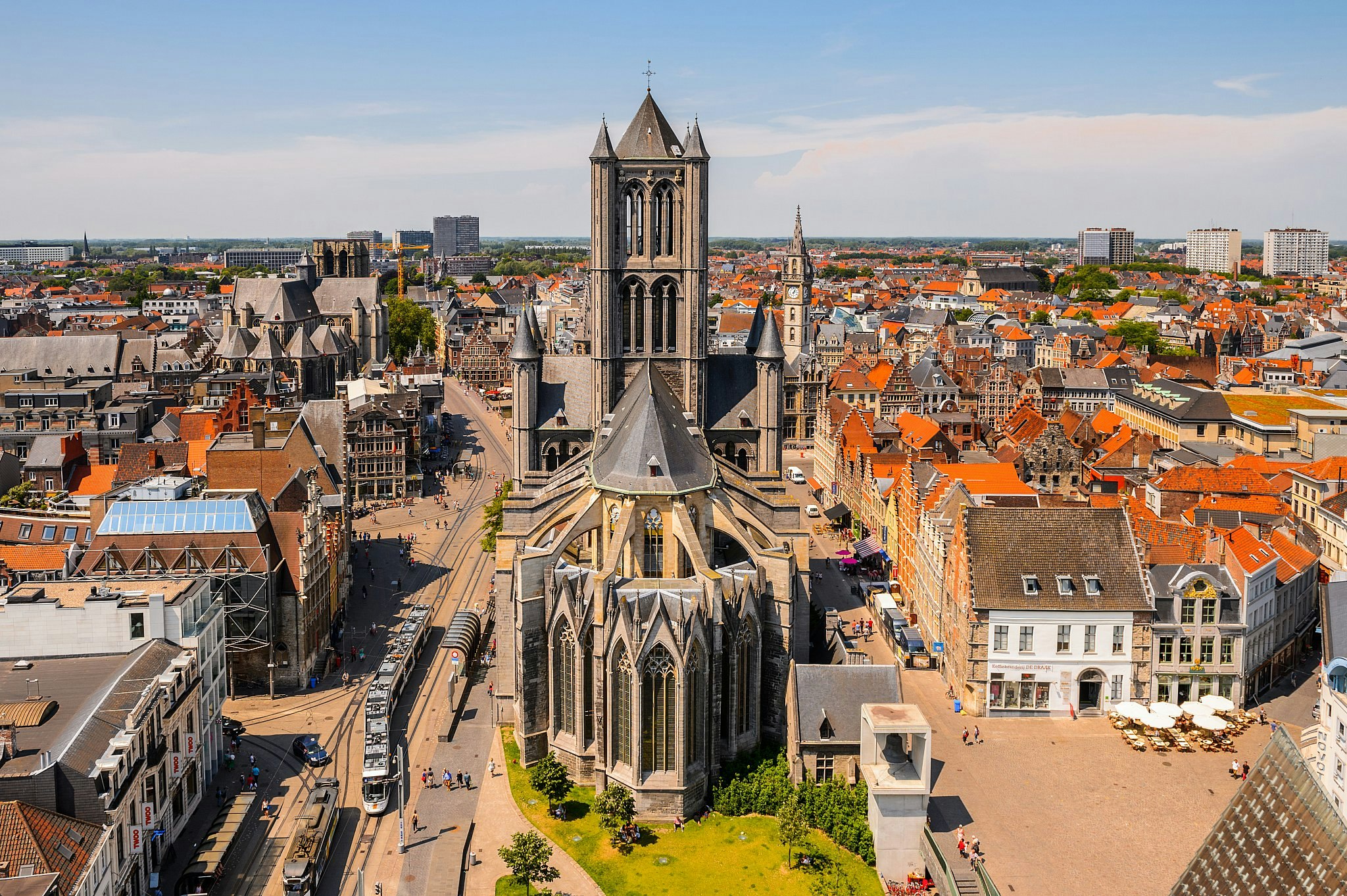 The grey stone St Bavo Cathedral rising majestically above the medieval old town of Ghent which surrounds it.